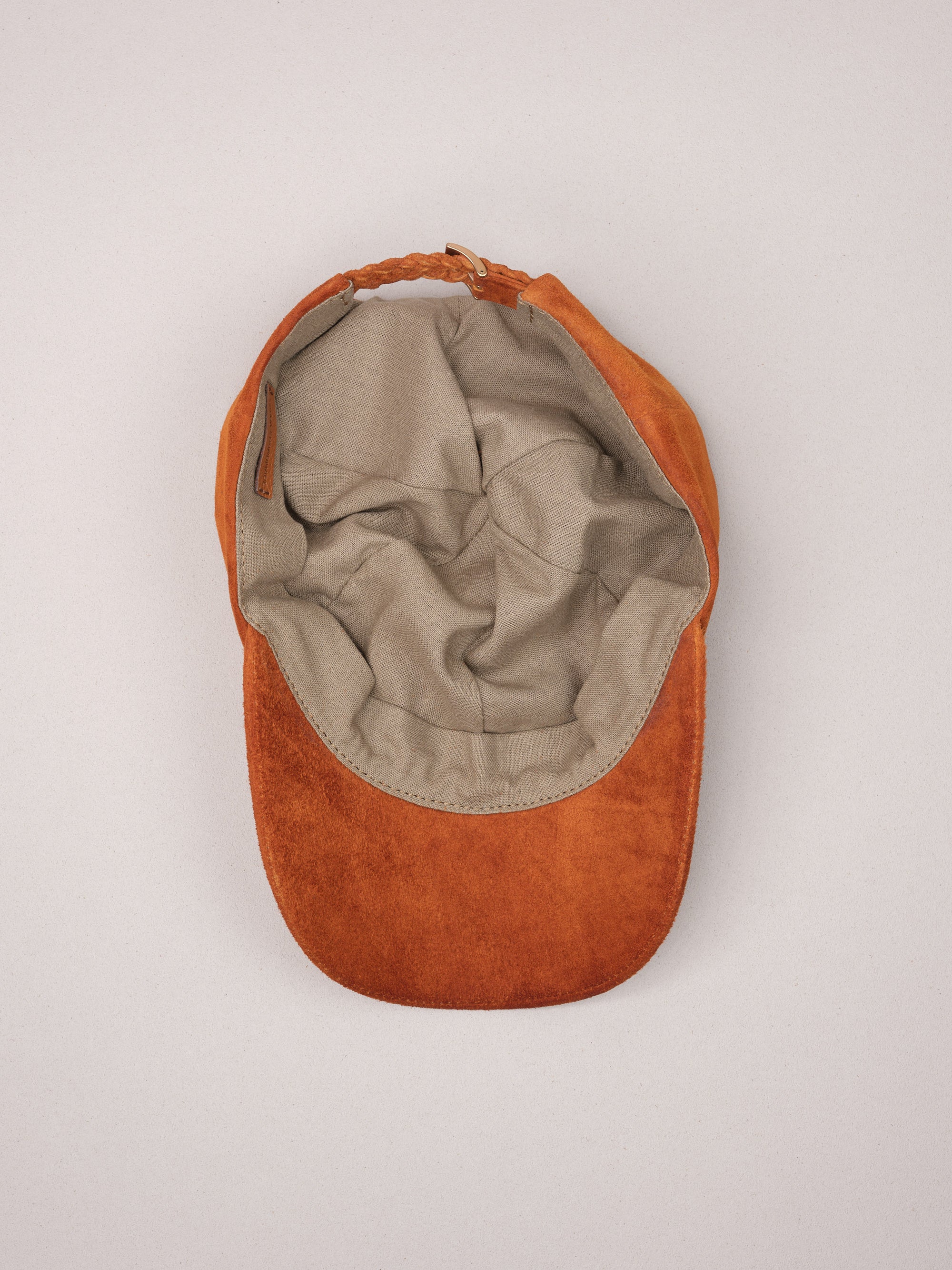 Soft natural linen lining inside the tan suede baseball cap.