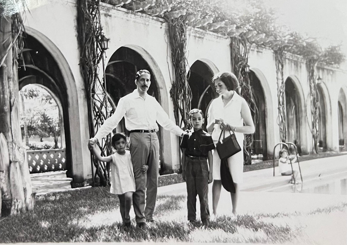 Old black-and-white family photograph under stone arches, from Capra Leather's founding story