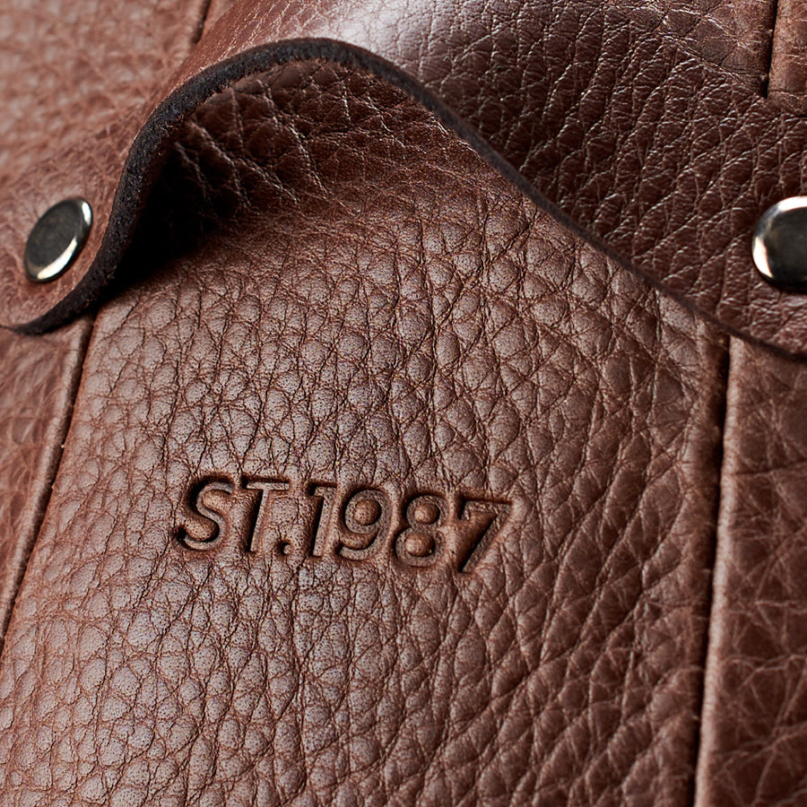 ST.1987 debossed into brown full-grain leather by Capra Leather