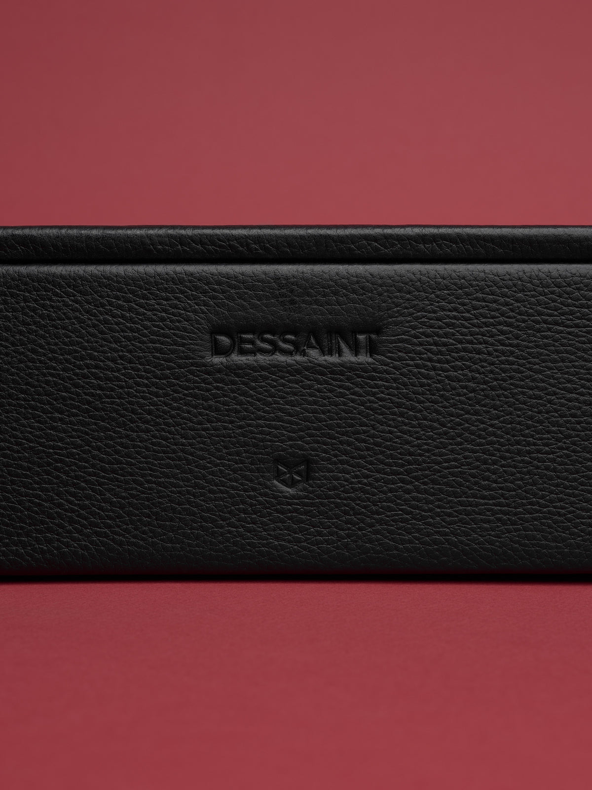 Custom embossing in the front of the black watch organizer by Capra Leather.