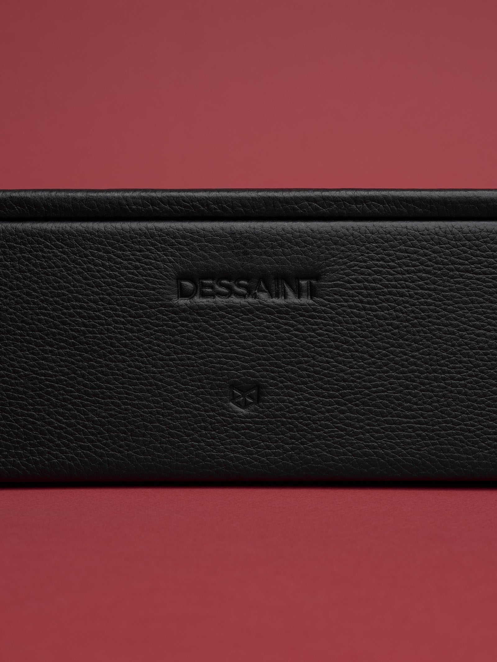 Custom embossing in the front of the black watch organizer by Capra Leather.