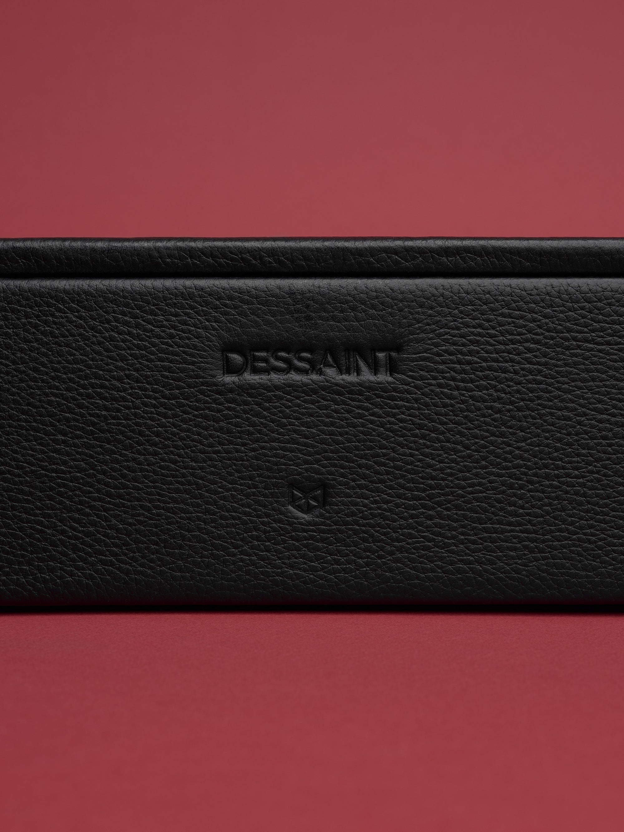 Custom embossing in the front of the black watch organizer by Capra Leather.