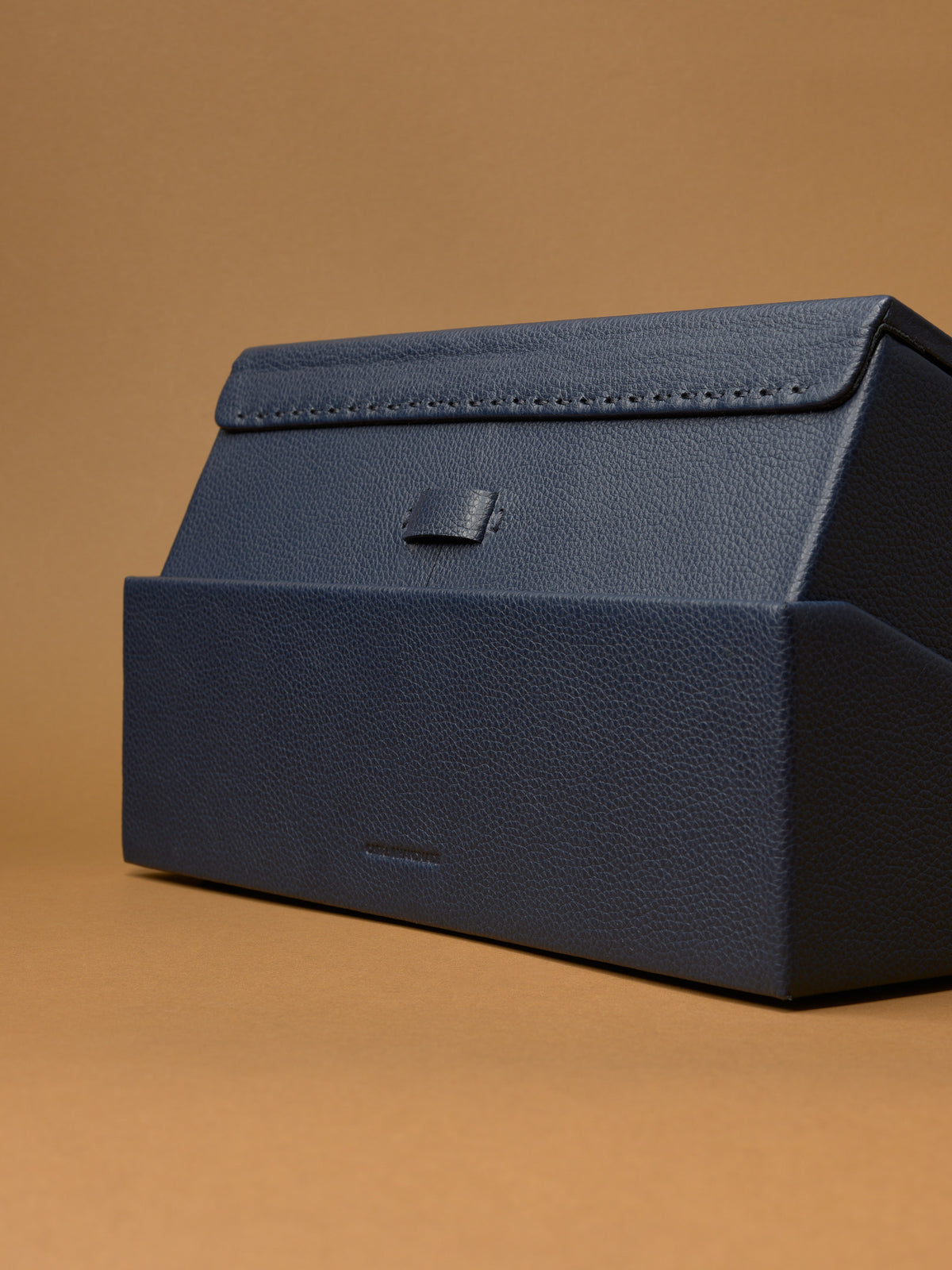 The Podium Close-up of the base of the Capra leather watch box, showing the textured grain.
