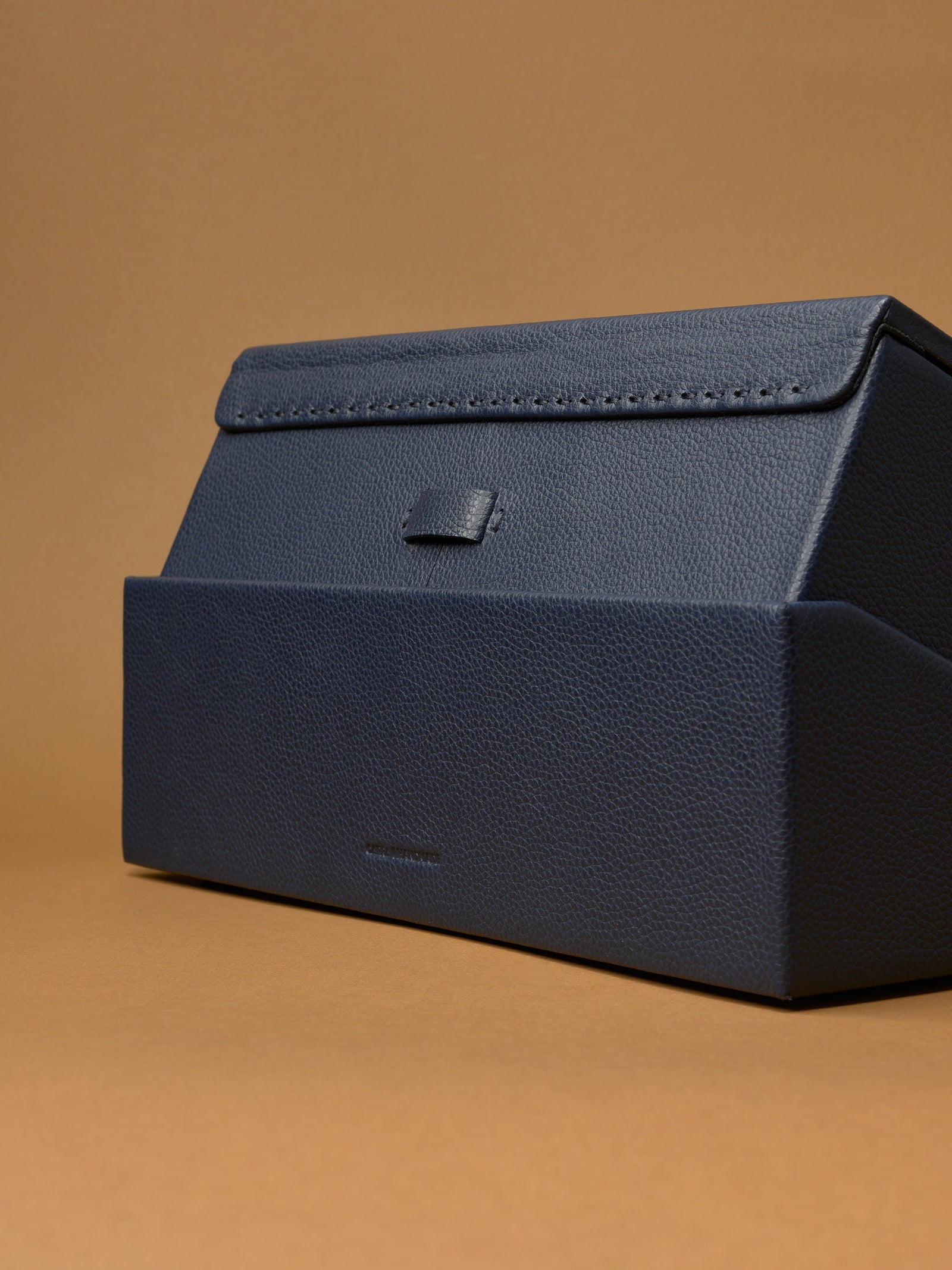 The Podium Close-up of the base of the Capra leather watch box, showing the textured grain.