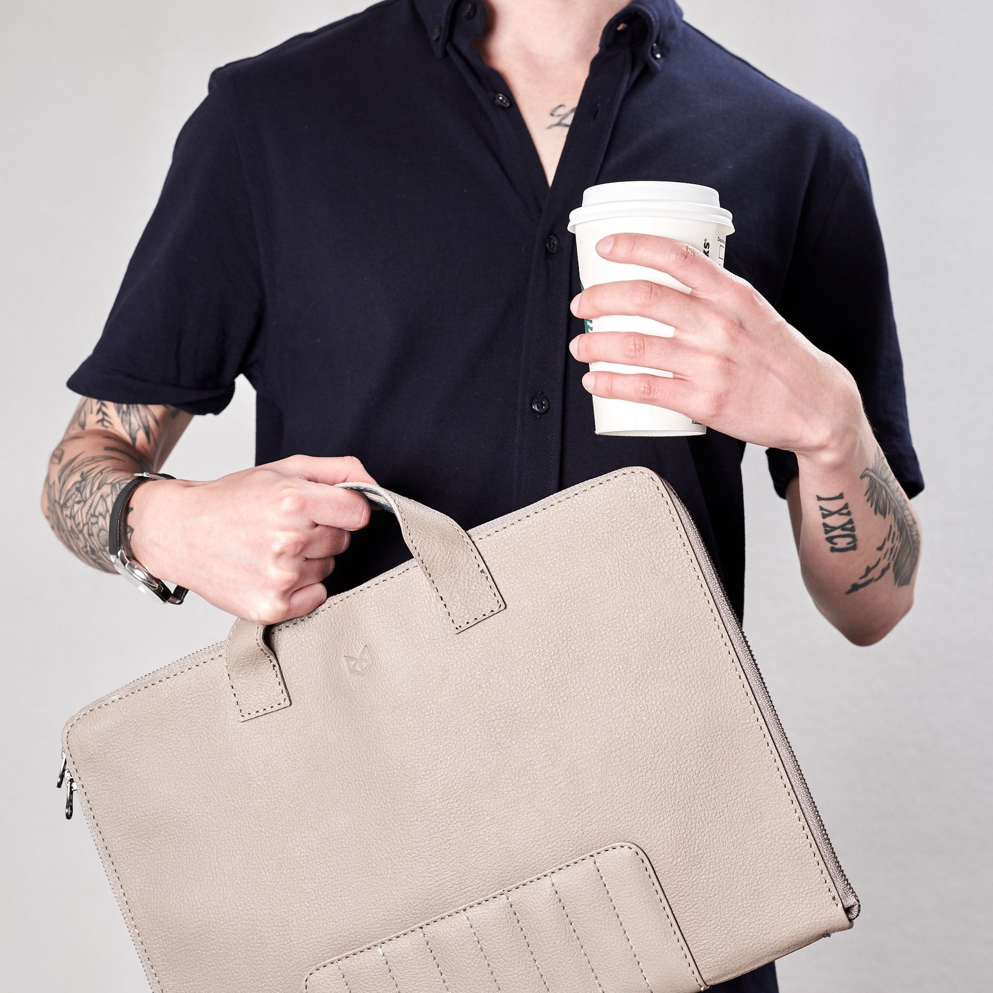 Biker grey portfolio style picture and coffee. Holding Biker with handles. Portfolio made by Capra Leather.