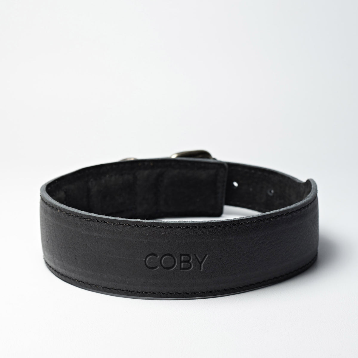 Handmade minimal black leather padded dog collar by Capra Leather. 