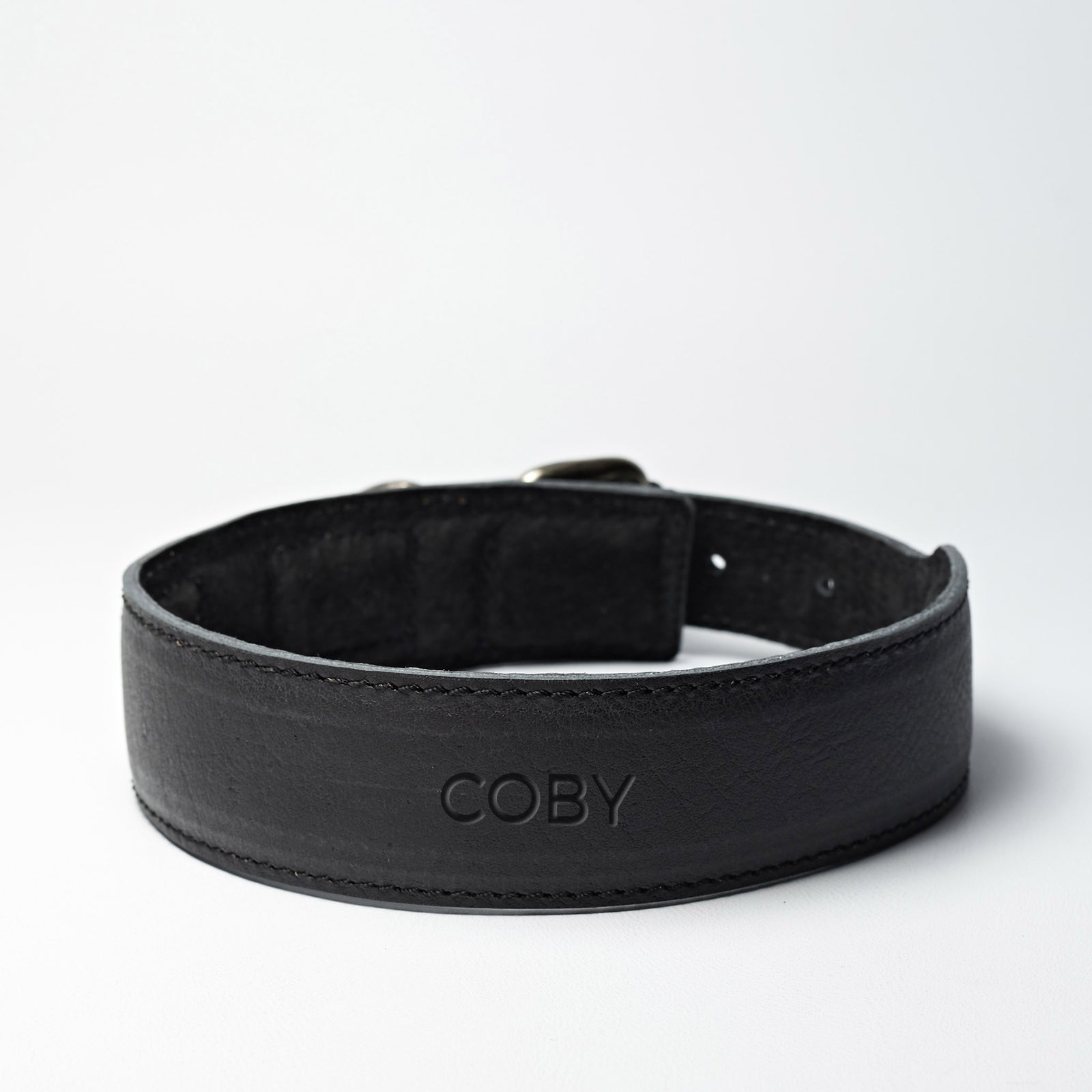 Handmade minimal black leather padded dog collar by Capra Leather. 
