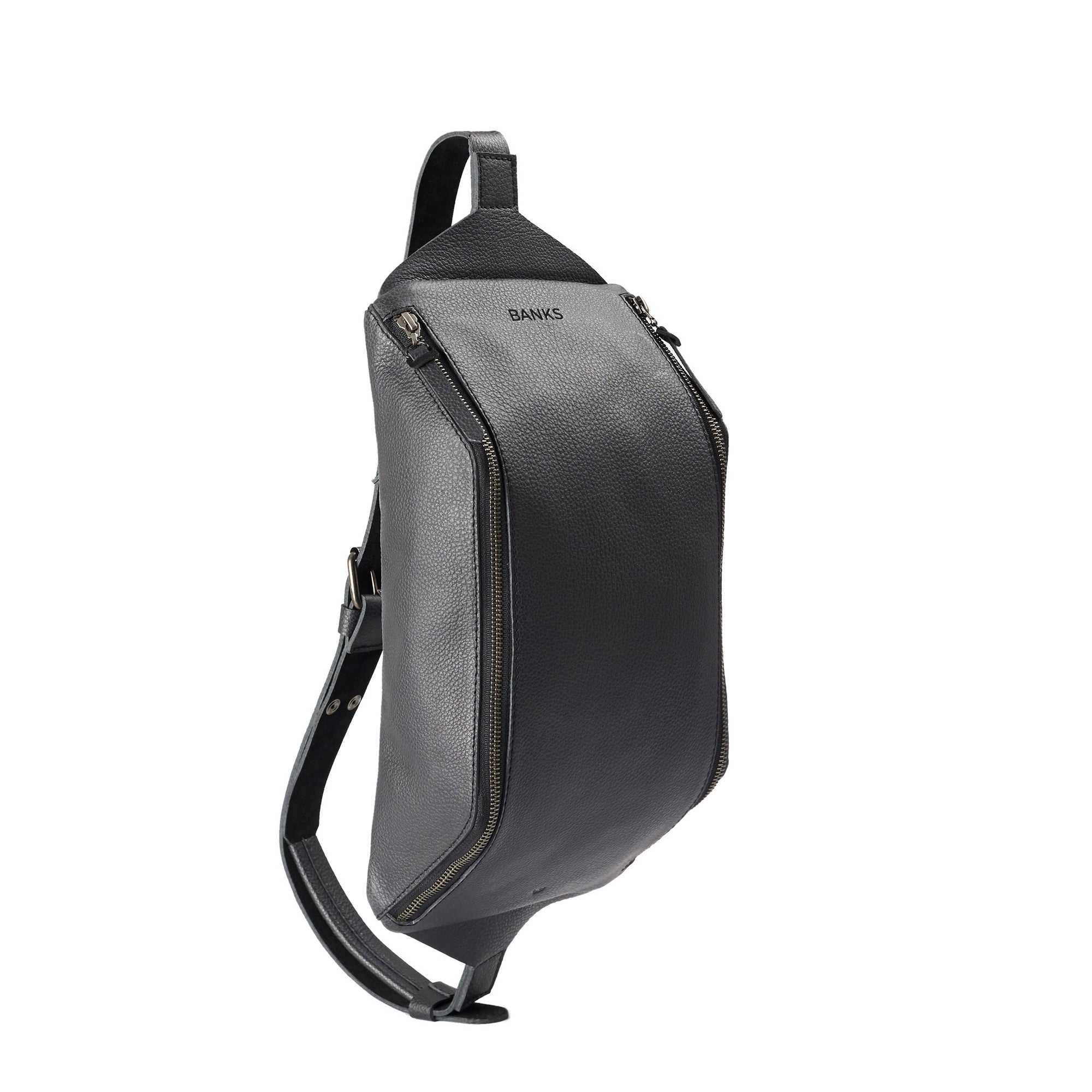 Engraving detail. Black Fenek sling bag backpack made by Capra Leather. Styling of over the shoulder festival bicycle bag.