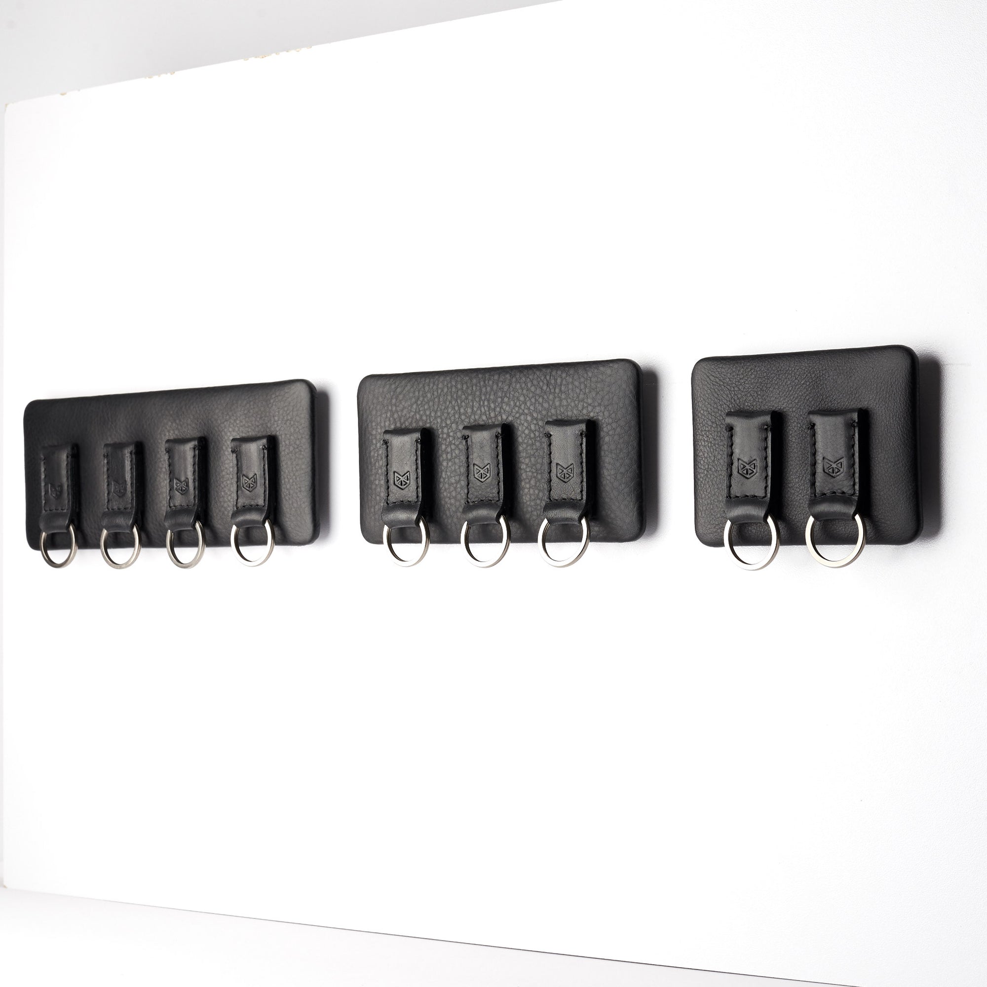 different sizes. Black leather magnetic key holder for wall decor. Entryway organizer decor. Home decoration. Keys organizer