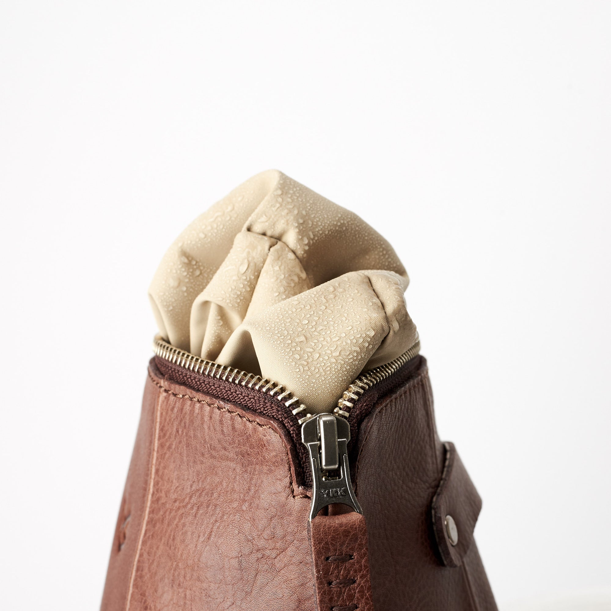 Detail, waterproof interior, hand stitched pull tabs. Brown leather boxer toiletry bag. Mens leather dopp kit travel bag