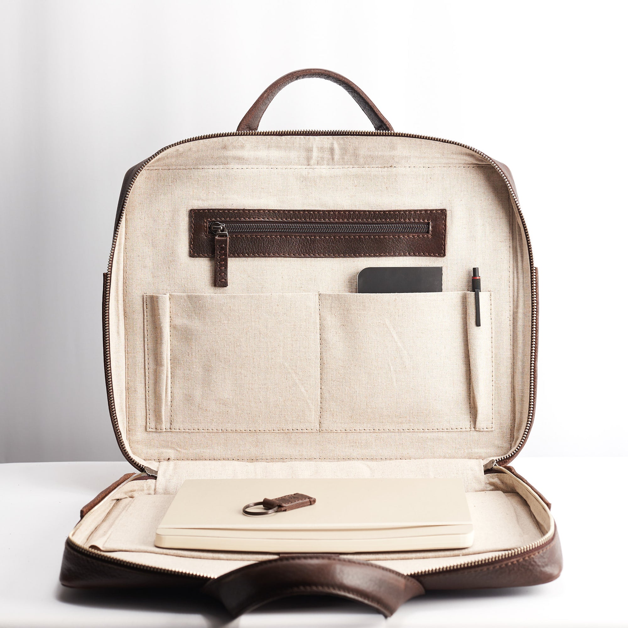 Interior pocket detail. Dark brown leather briefcase for men. Linen interior. Workbag for Macbook Pro 13inch 15inch