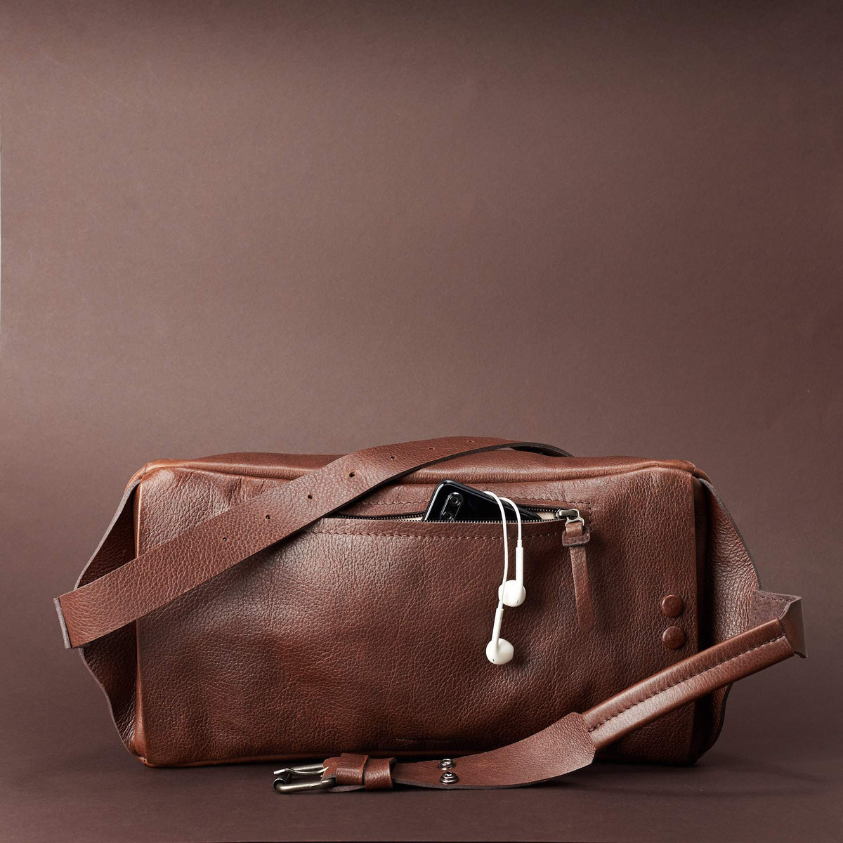 Styling back pocket of leather crossbody for easy access. Fenek Sling Bag Brown by Capra Leather
