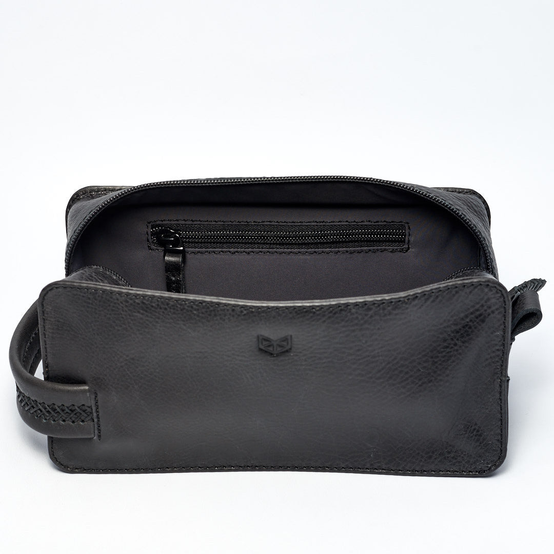 Leather toiletry bag with interior pocket for small essentials. Black leather shaving bag for mens gifts