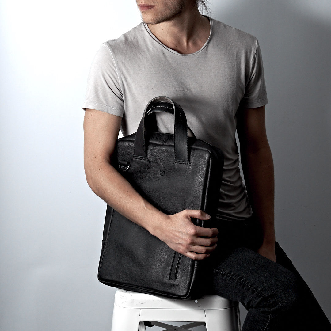 Style photo. Black vertical briefcase. Minimalist style workbag for office