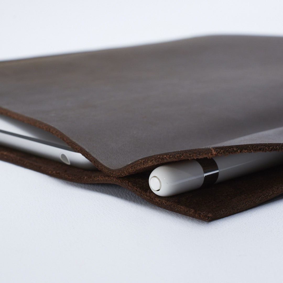 Apple pencil detail. Brown iPad pro leather case with pen holder. Soft leather interior
