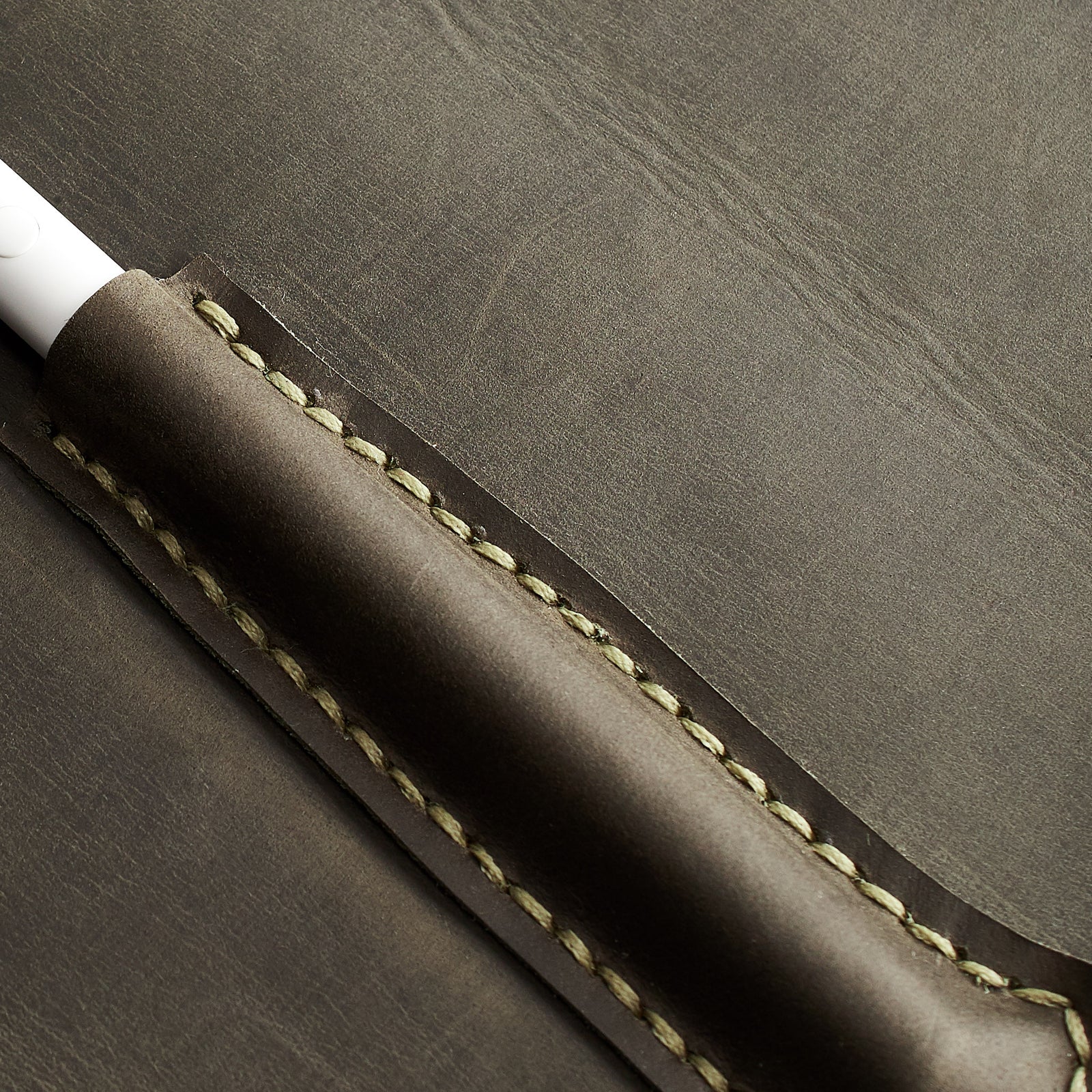 handstitch detail. Green Pixelbook Chromebook leather sleeve with  pencil holder