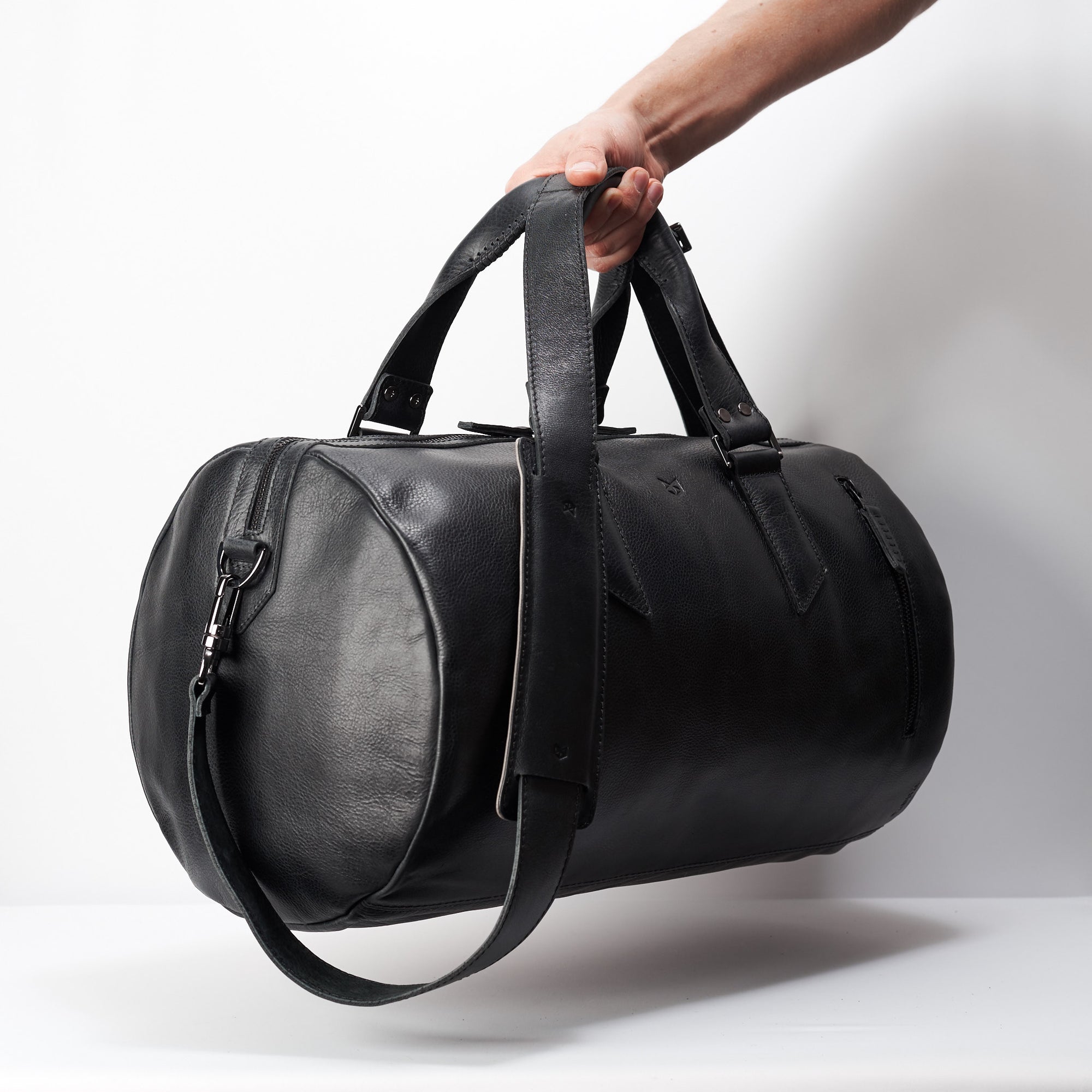Style outside photo. Black leather duffle handbag for men. Travel designer bag 