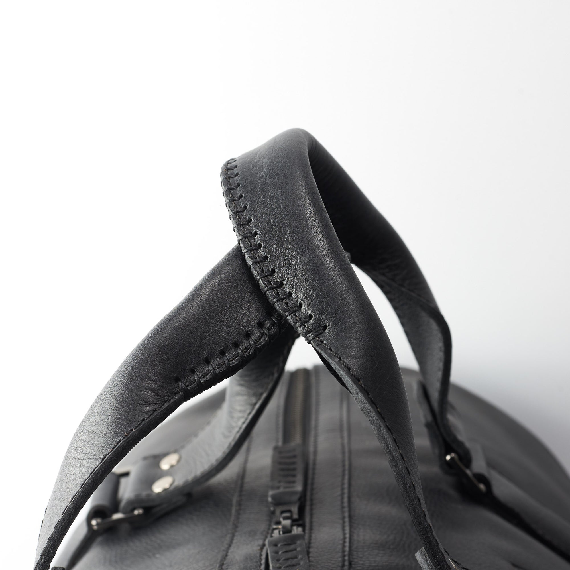 Hand stitched handles. Black leather athletic duffle bag for weekend