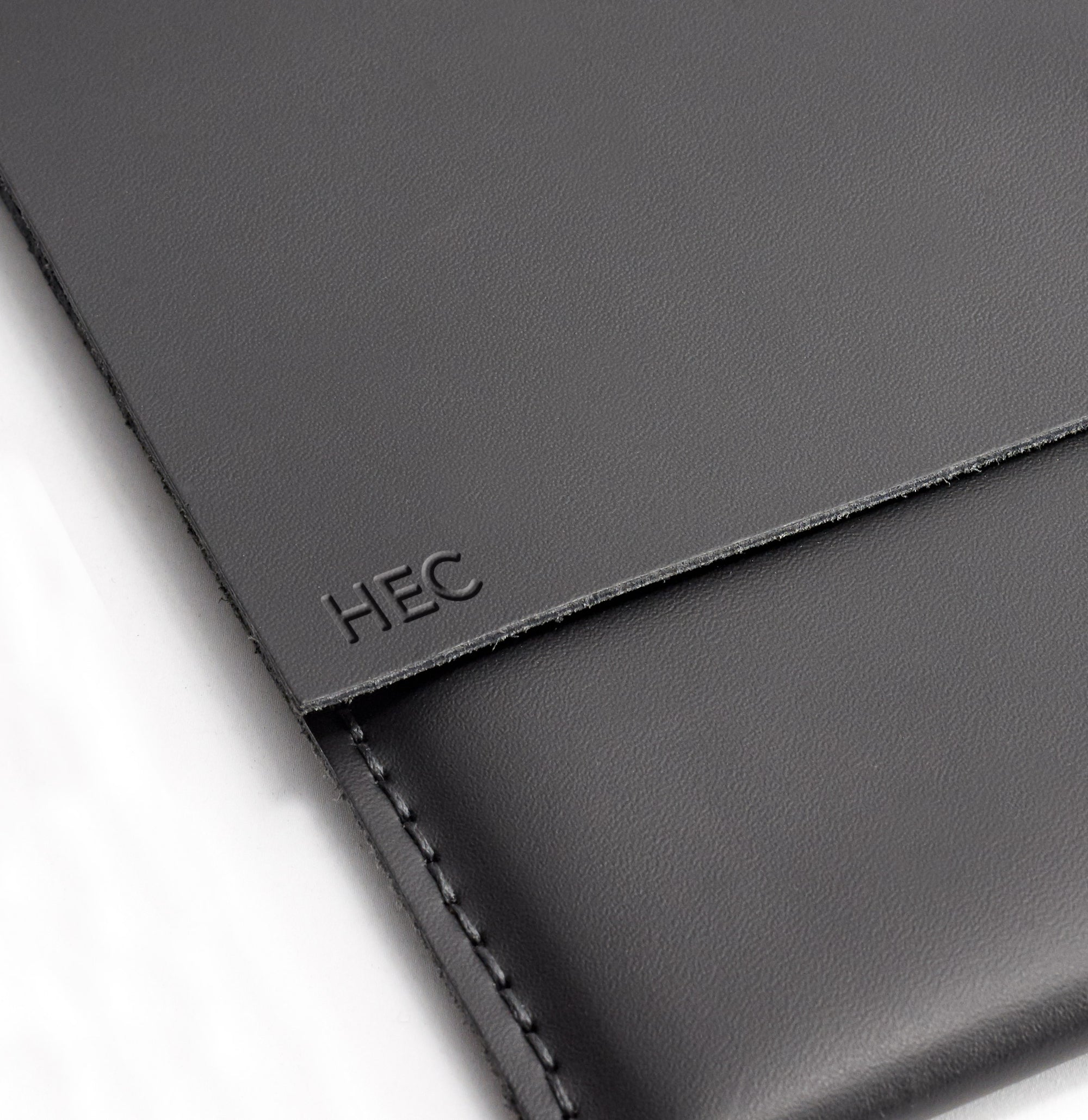 Engraving detail . ASUS Zenbook Pro Duo Black leather case with pen holder. ASUS laptop mens folio