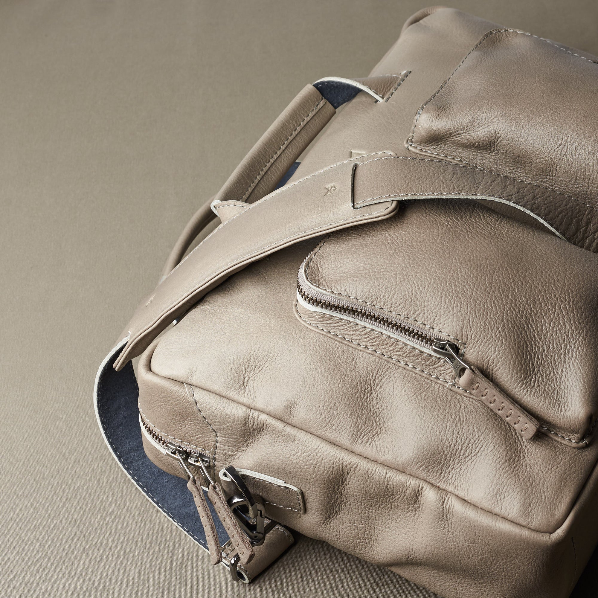 Styling side view. Grey handmade leather messenger bag for Men by Capra Leather. Commuter bag, mens weekender bag 
