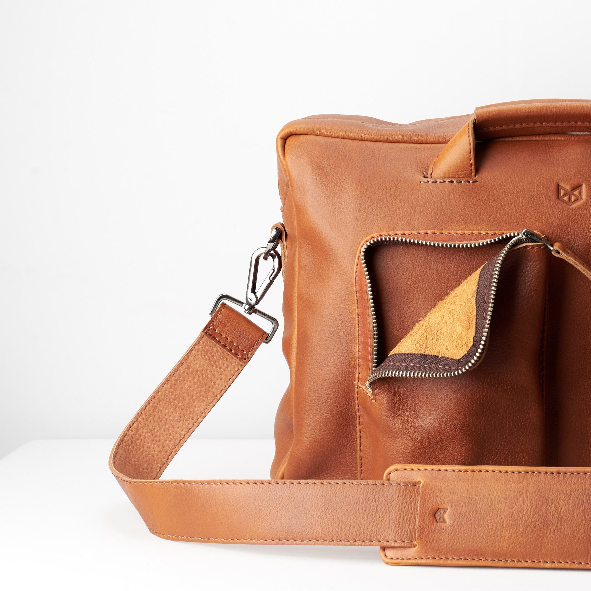 leather interior pockets. Tan handmade leather messenger bag for Men by Capra Leather. Tech bag, mens weekender bag 