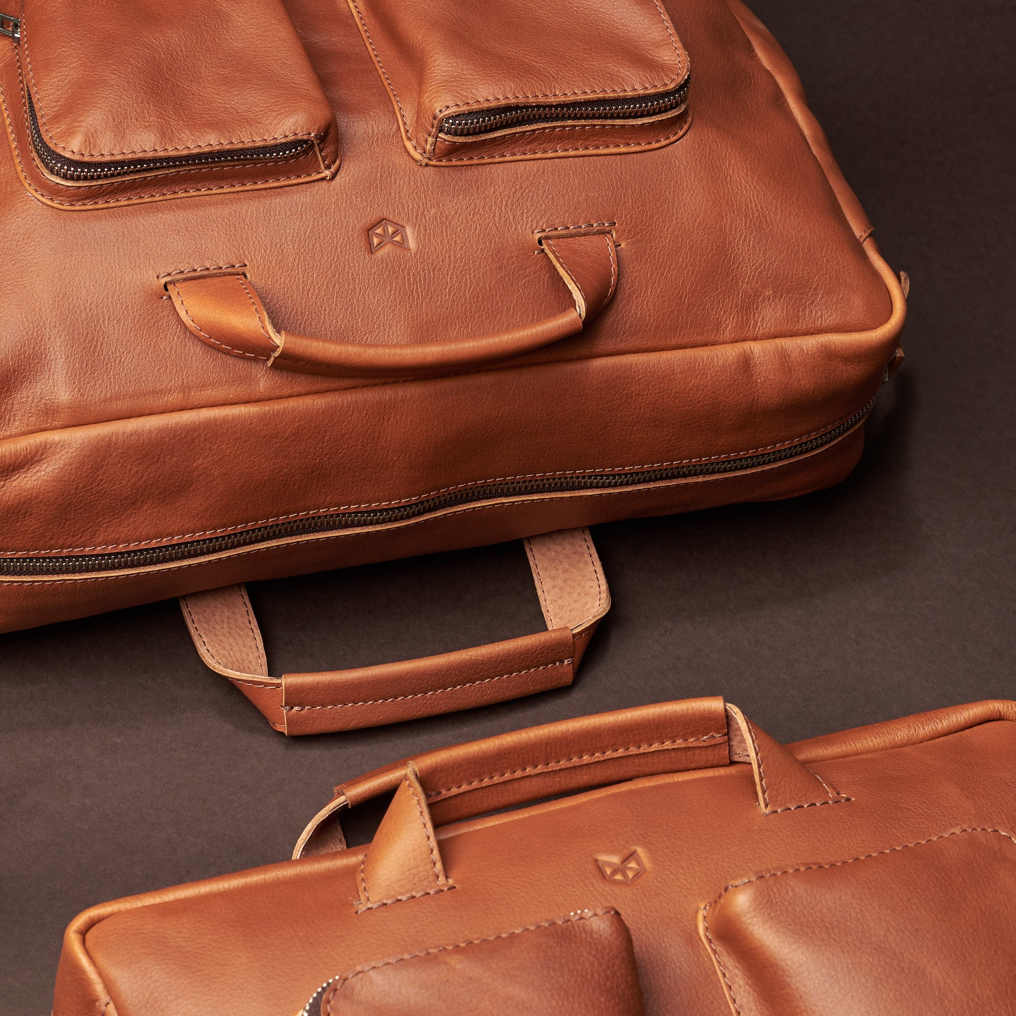 two-size bag styling. Tan handmade leather messenger bag for Men by Capra Leather. Tech bag, mens weekender bag 