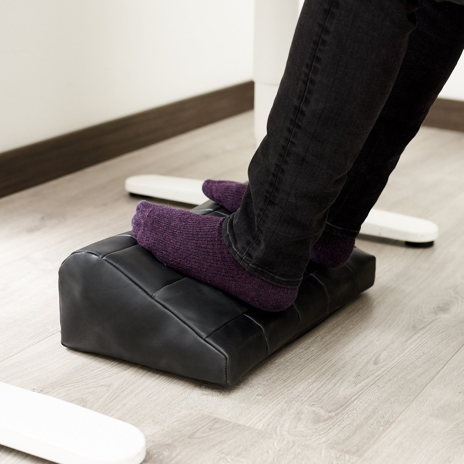 Cover. Ergonomic under desk footrest cover in black by Capra Leather