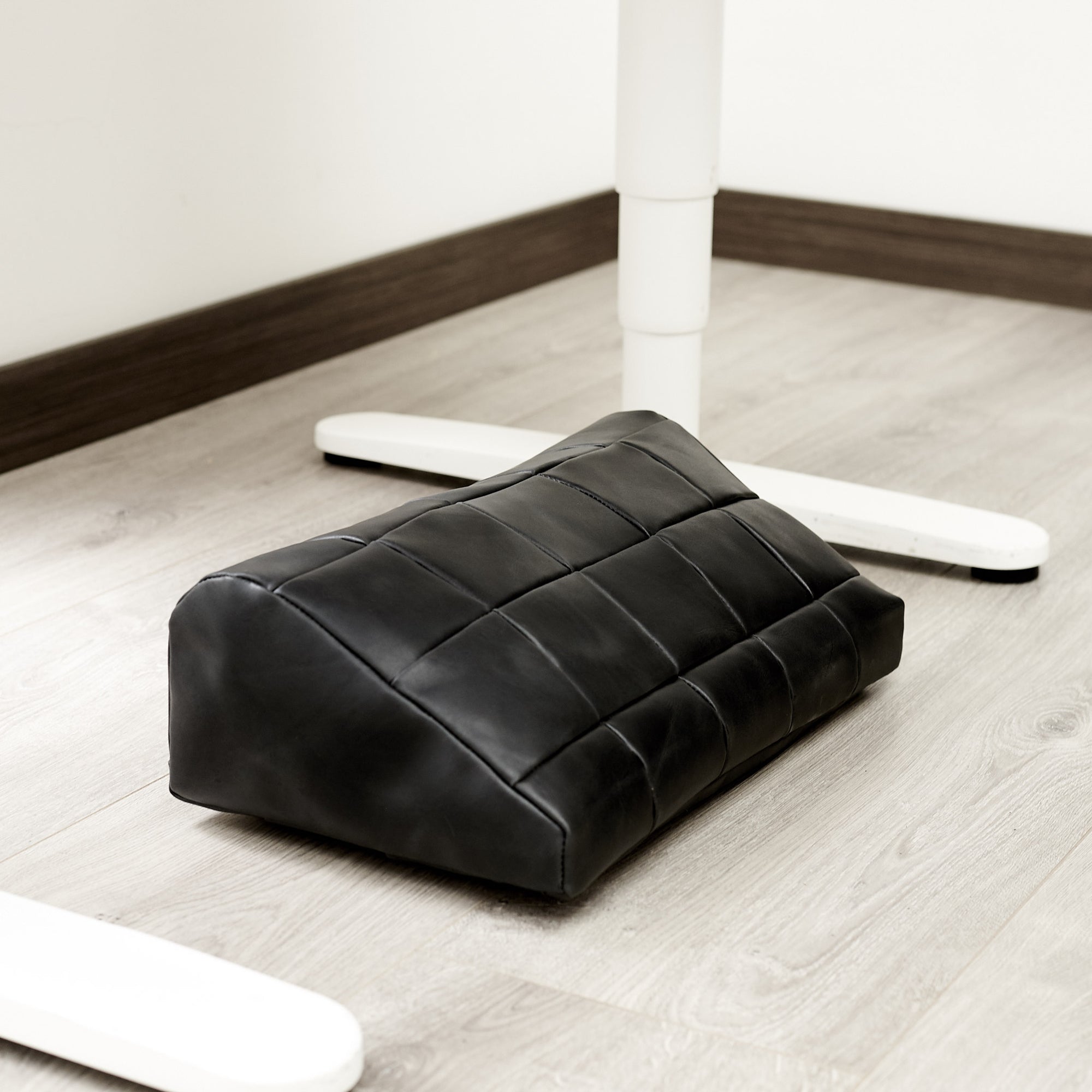 WFH. Ergonomic under desk footrest cover in black by Capra Leather