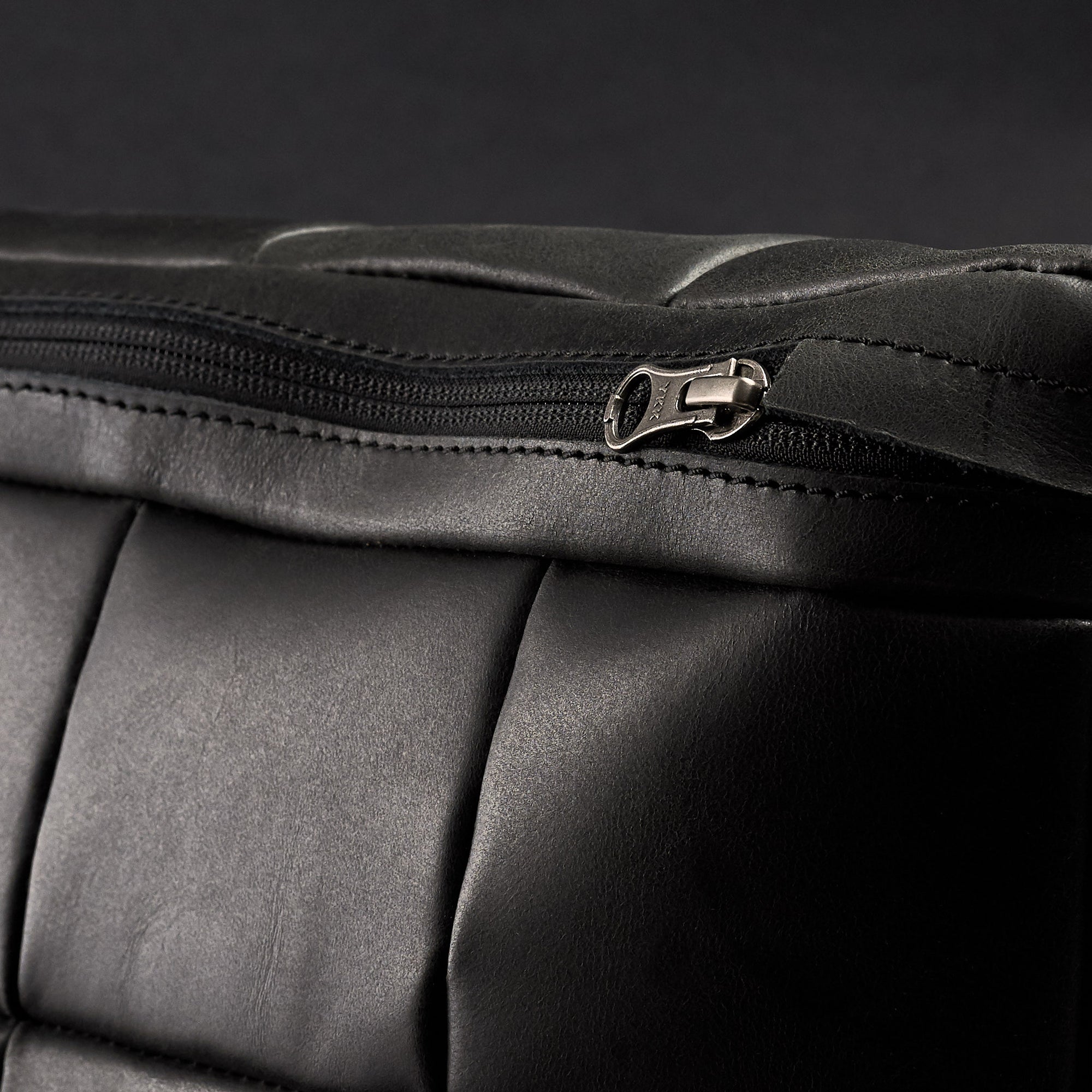 Zipper detail. Ergonomic under desk footrest cover in black by Capra Leather
