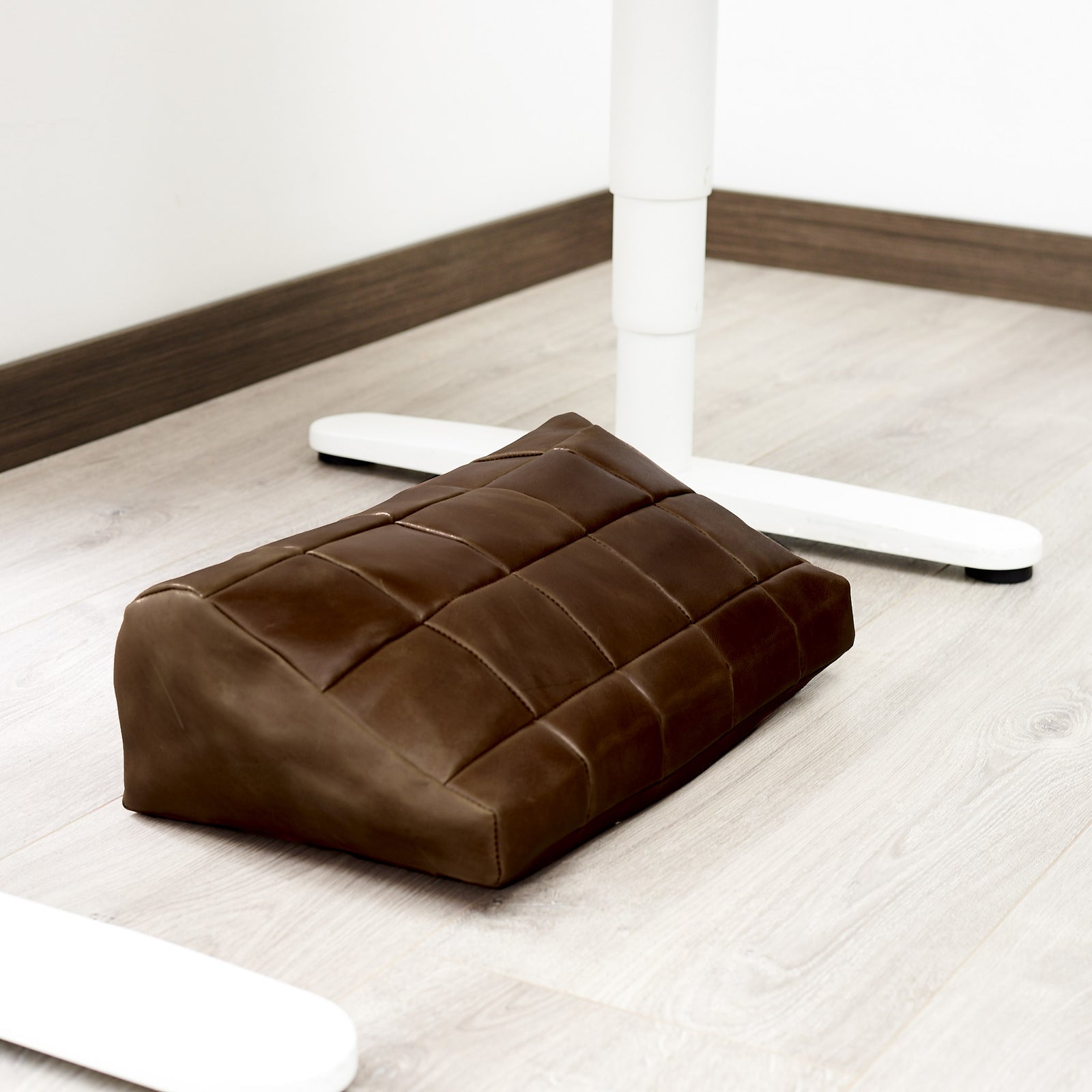 WFH. Ergonomic under desk footrest cover in brown by Capra Leather