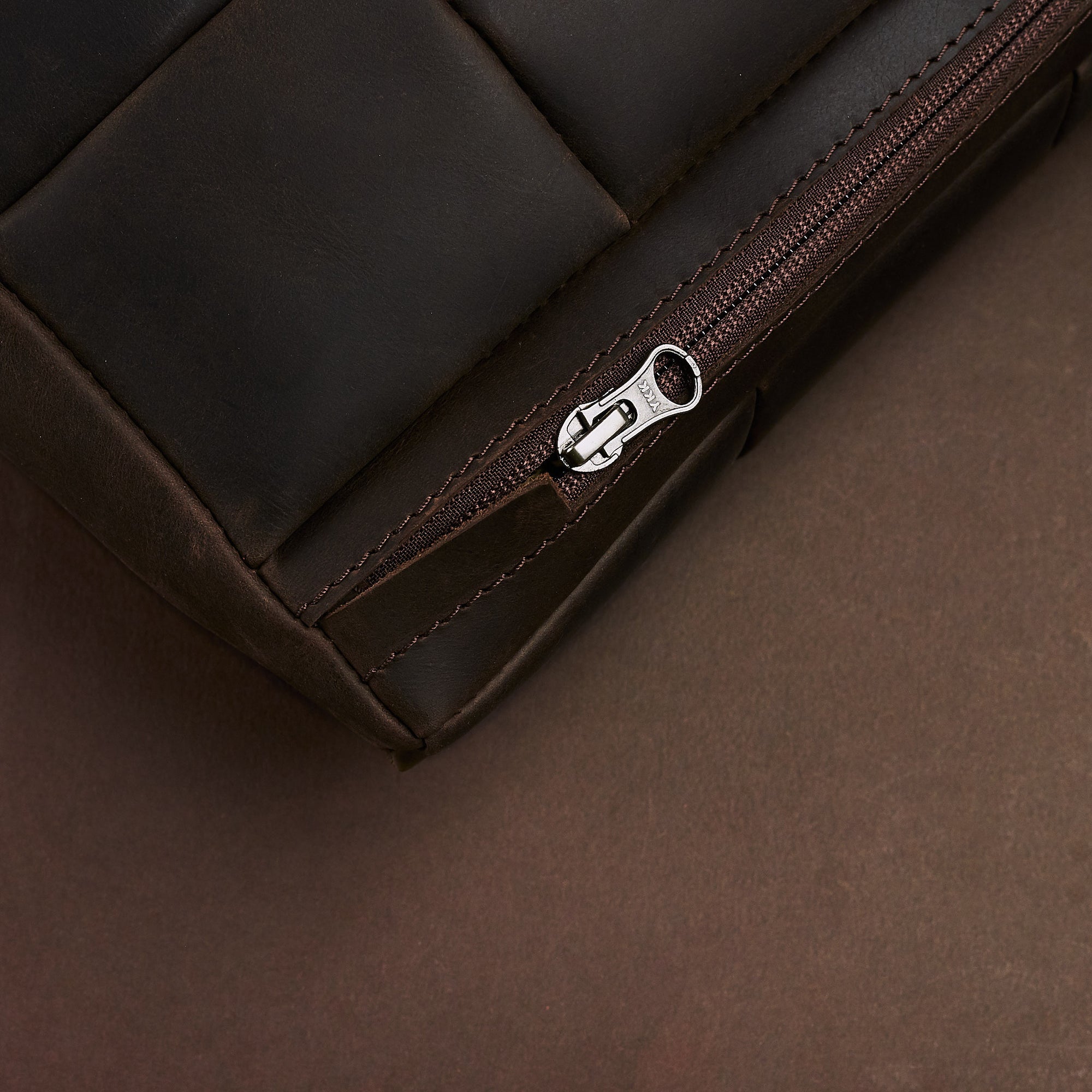 Zipper detail. Ergonomic under desk footrest cover in brown by Capra Leather