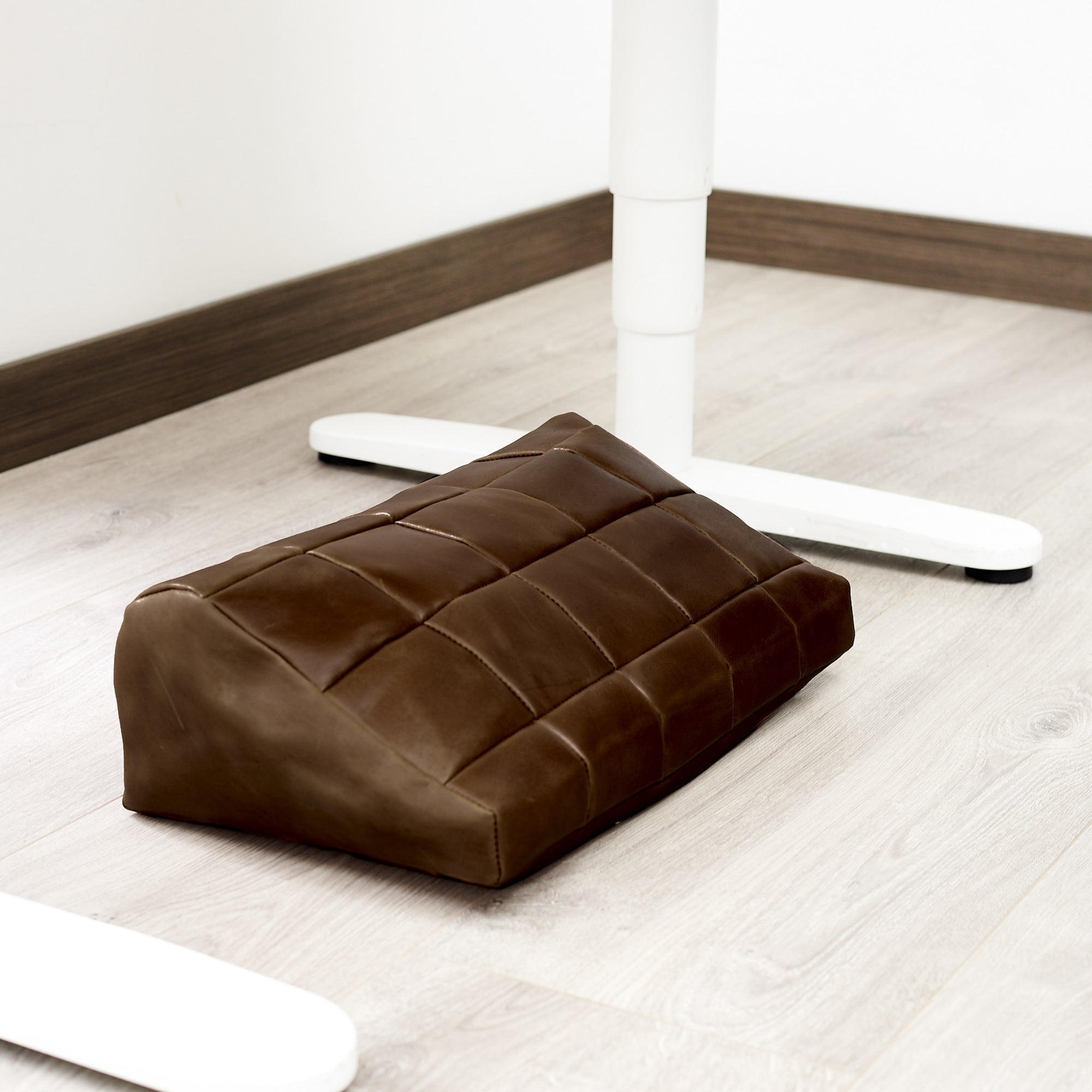WFH. Ergonomic under desk footrest cover in brown by Capra Leather
