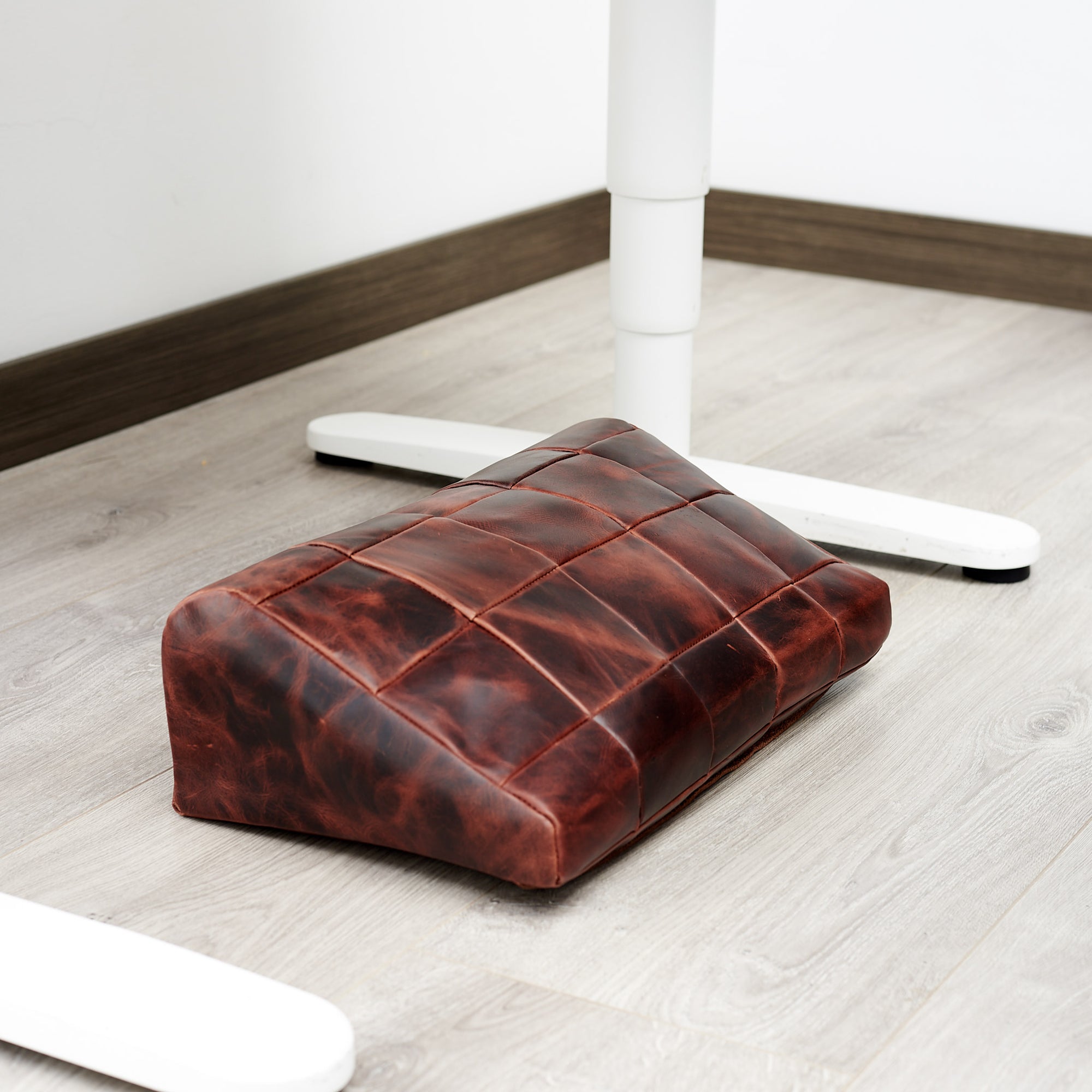 WFH. Ergonomic under desk footrest cover in distressed cognac by Capra Leather
