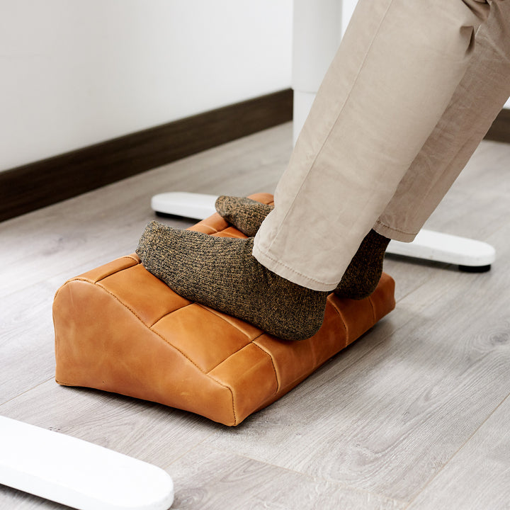 Cover. Ergonomic under desk footrest cover in tan by Capra Leather