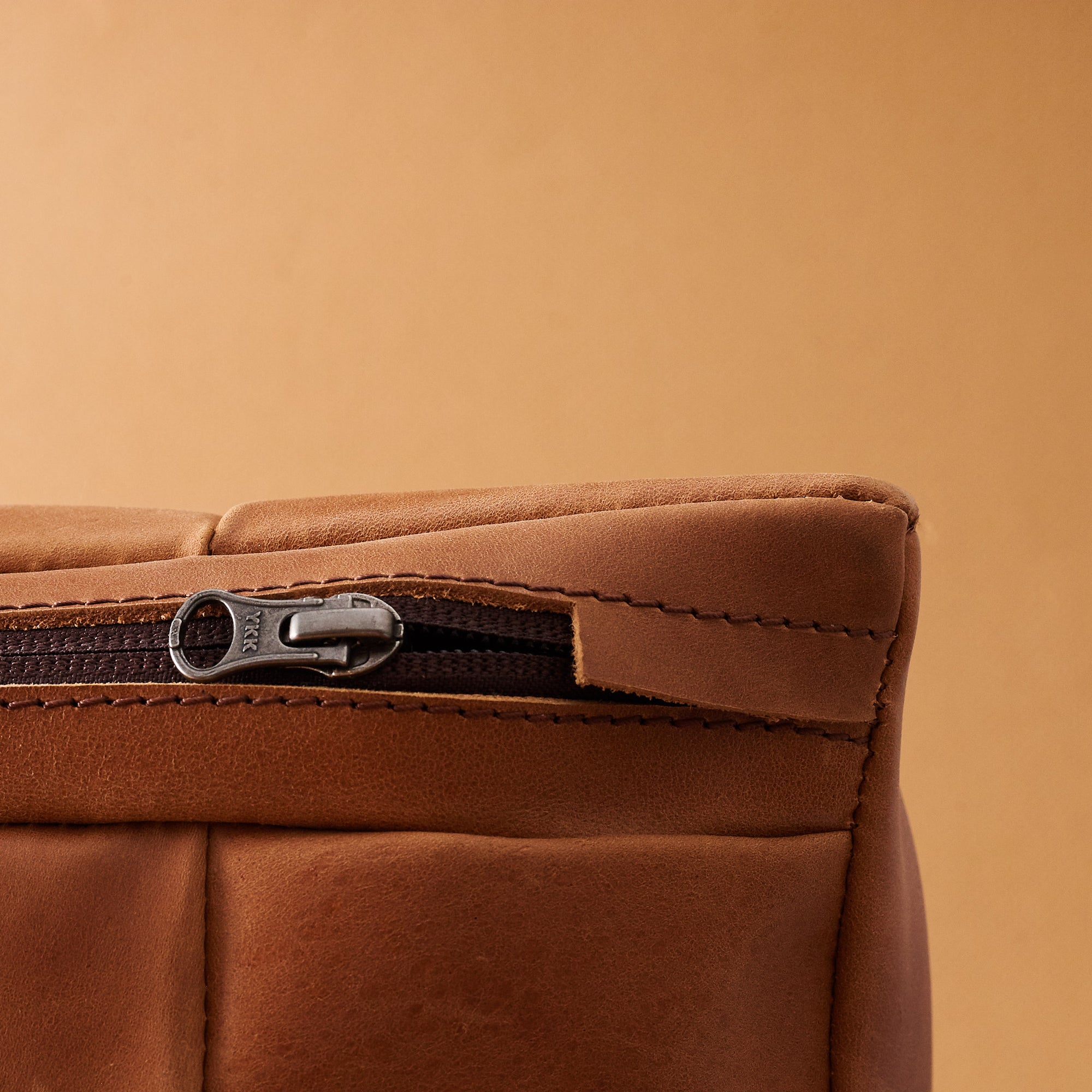 Zipper detail. Ergonomic under desk footrest cover in tan by Capra Leather