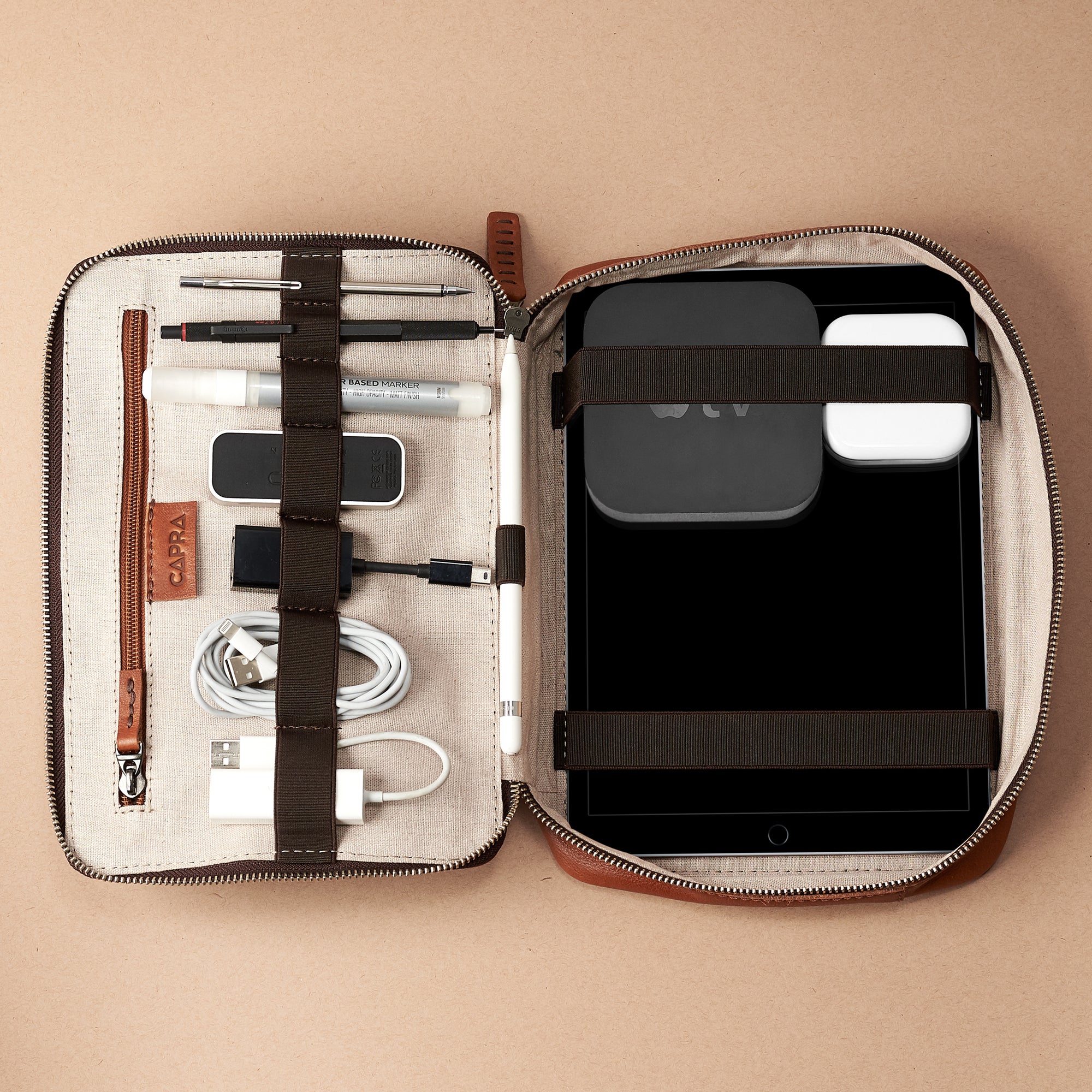 Electronics storage. Tan travel electronics organizer. Leather tech pouch by Capra. Fits iPad Pro