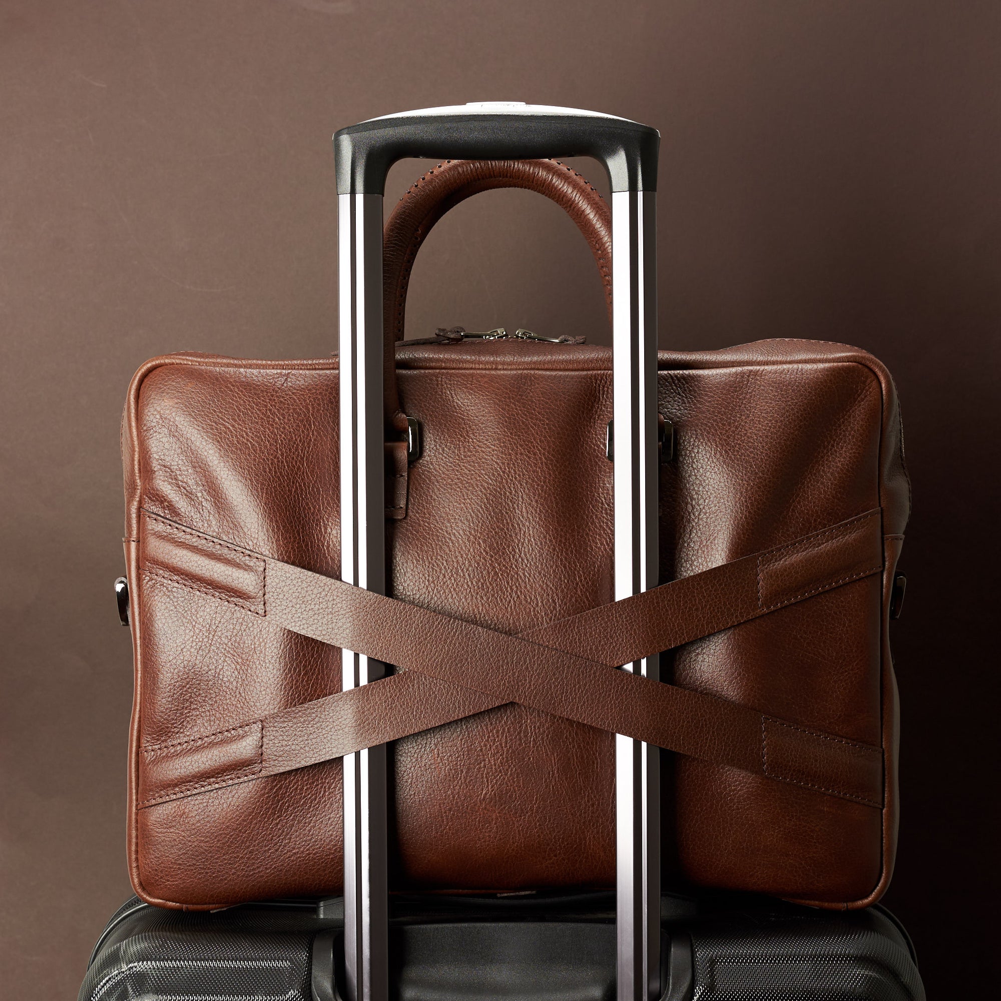 Luggage strap in x shape for messenger bag. Brown leather briefcase laptop bag for men. Gazeli laptop briefcase by Capra Leather.