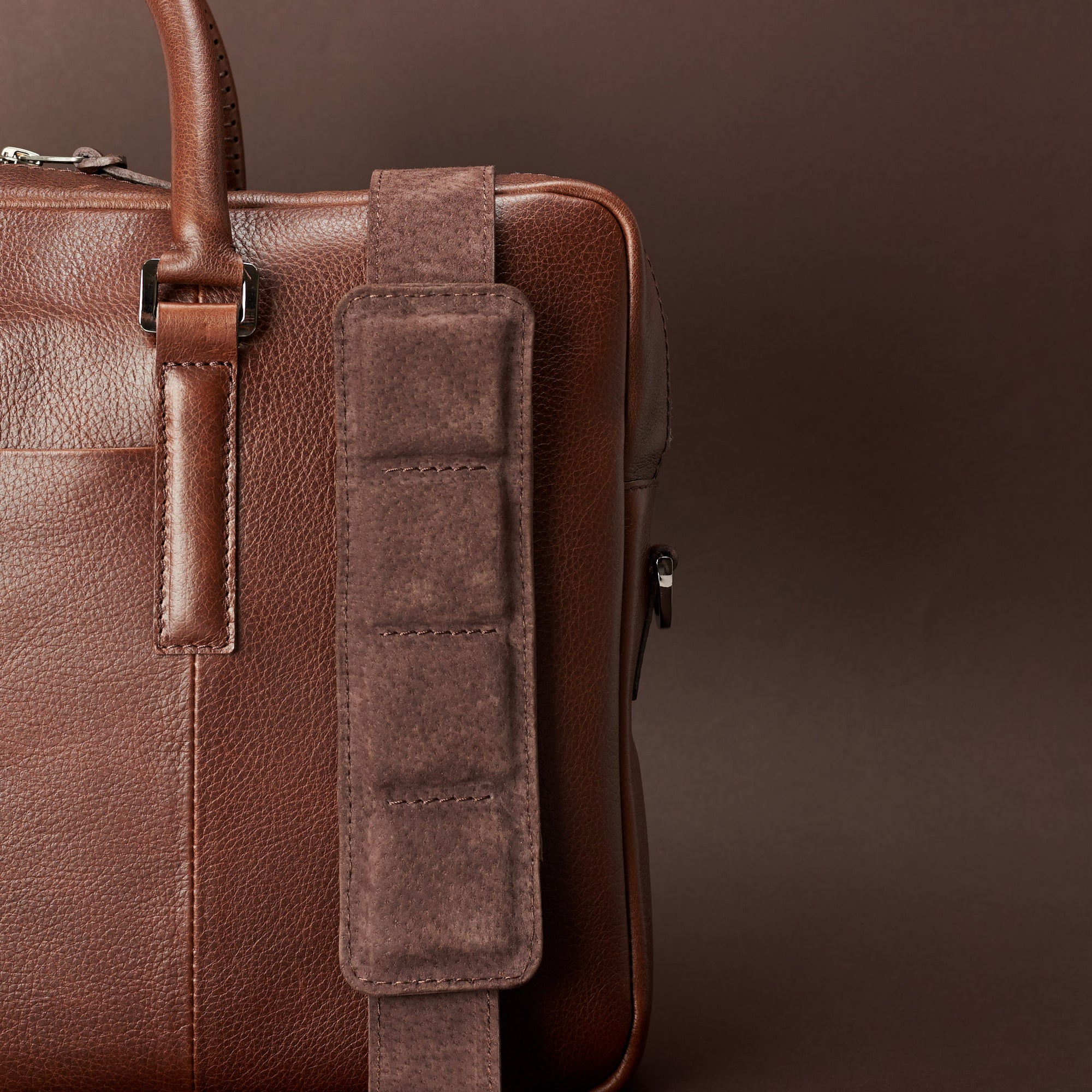 Detail of strap of shoulder bag. Brown leather briefcase laptop bag for men. Gazeli laptop briefcase by Capra Leather.
