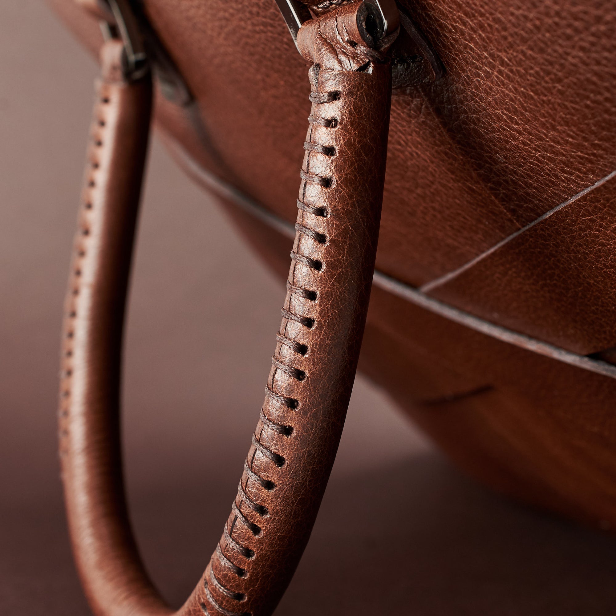 Hand stitch cylindrical handle detail. Brown leather briefcase laptop bag for men. Gazeli laptop briefcase by Capra Leather.