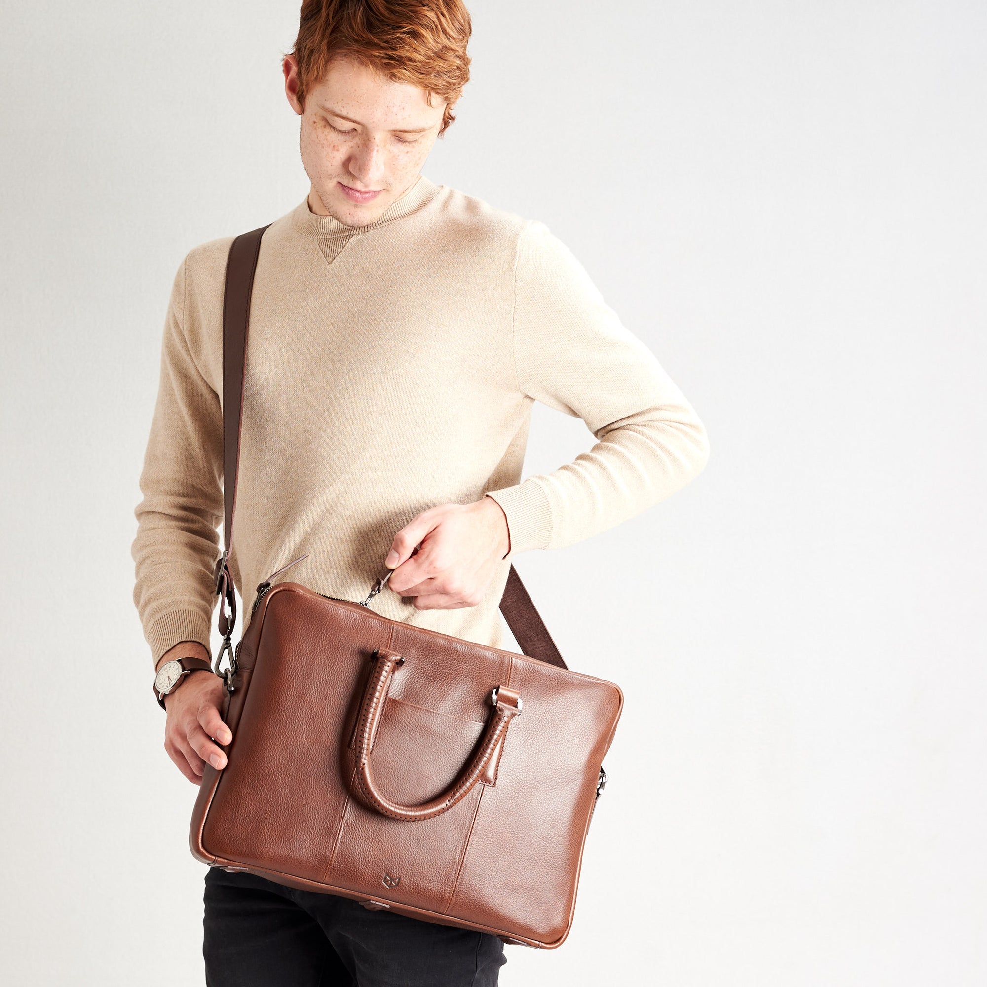 Shoulder bag in use by model. Brown leather briefcase laptop bag for men. Gazeli laptop briefcase by Capra Leather