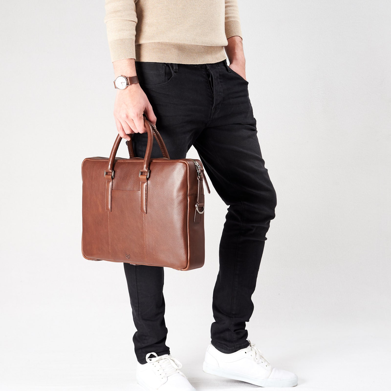 Style view, model holding bussiness document portfolio bag .Brown leather briefcase laptop bag for men. Gazeli laptop briefcase by Capra Leather.