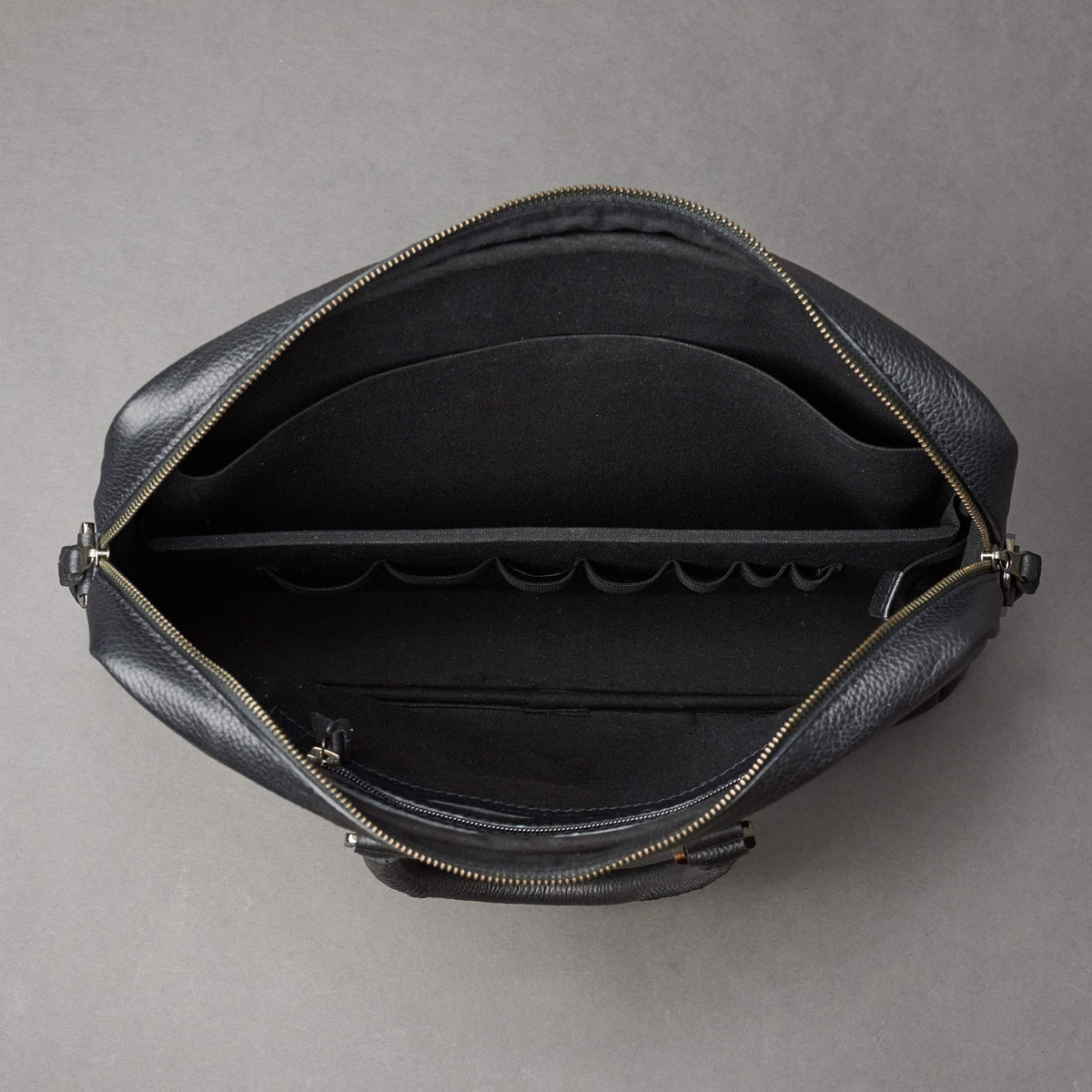 Interior with 7 division slots .Black leather briefcase laptop bag for men. Gazeli laptop briefcase by Capra Leather.