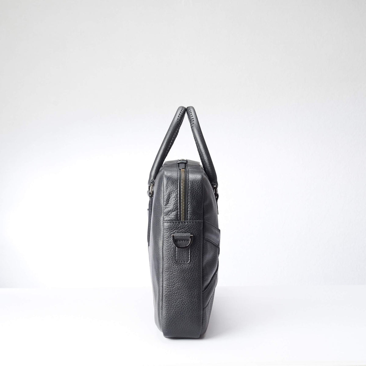 Side view of soft office and workbag . Black leather briefcase laptop bag for men. Gazeli laptop briefcase by Capra Leather.