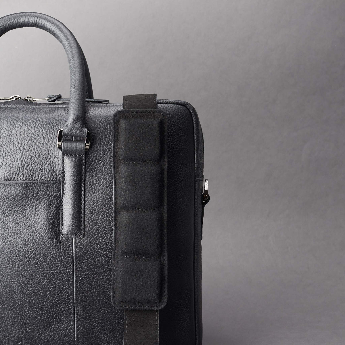 Detail of strap of shoulder bag. Black leather briefcase laptop bag for men. Gazeli laptop briefcase by Capra Leather.