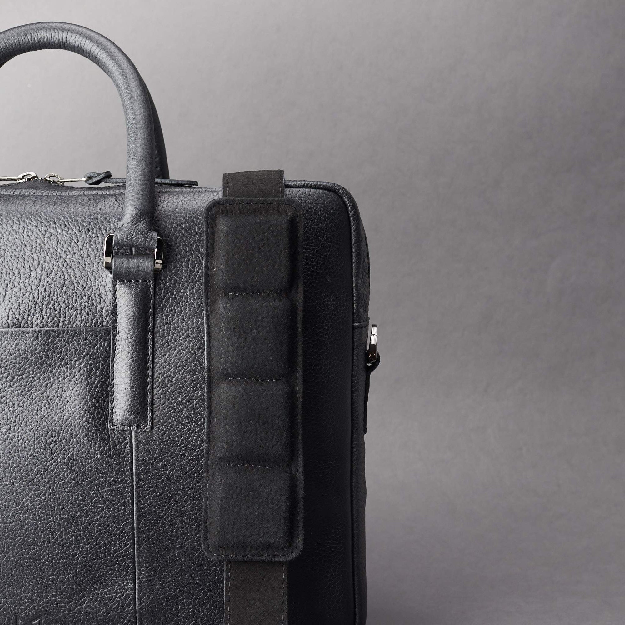 Detail of strap of shoulder bag. Black leather briefcase laptop bag for men. Gazeli laptop briefcase by Capra Leather.
