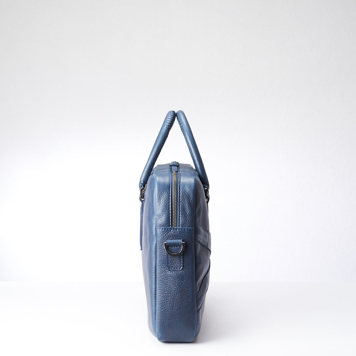 Side view of soft office and workbag .Blue leather briefcase laptop bag for men. Gazeli laptop briefcase by Capra Leather.