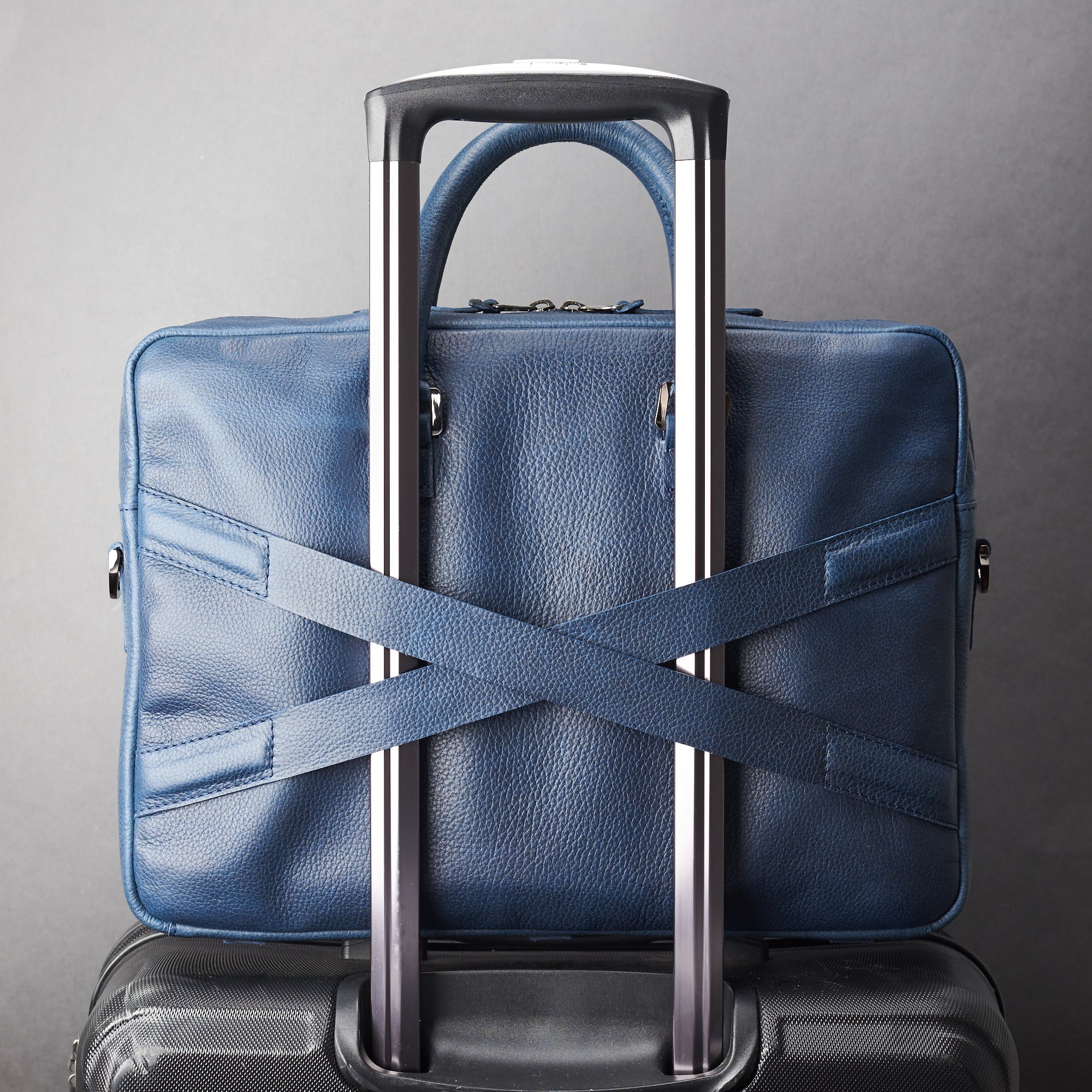 Luggage strap in x shape for messenger bag. Blue leather briefcase laptop bag for men. Gazeli laptop briefcase by Capra Leather.