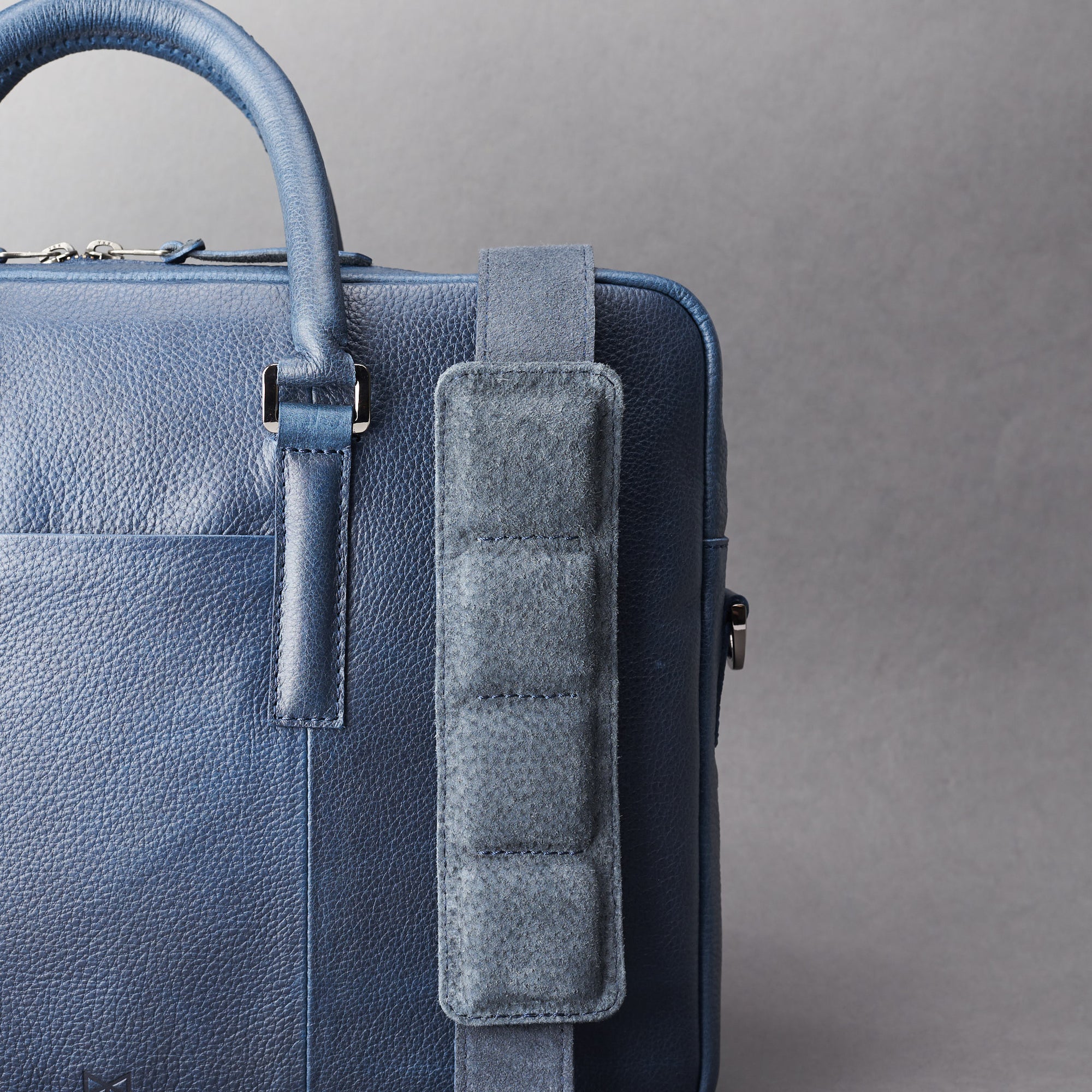 Detail of strap of shoulder bag. Blue leather briefcase laptop bag for men. Gazeli laptop briefcase by Capra Leather.