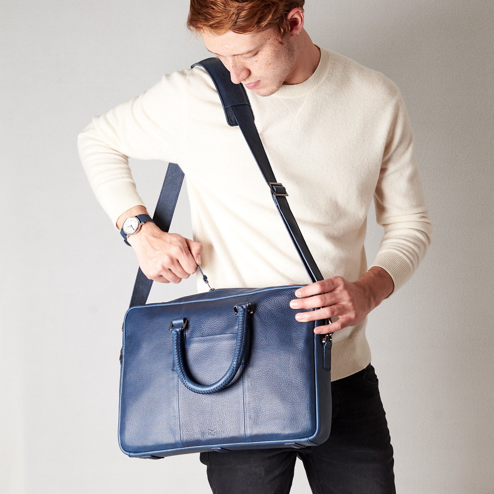 Shoulder bag in use side view of workbag. Blue leather briefcase laptop bag for men. Gazeli laptop briefcase by Capra Leather.