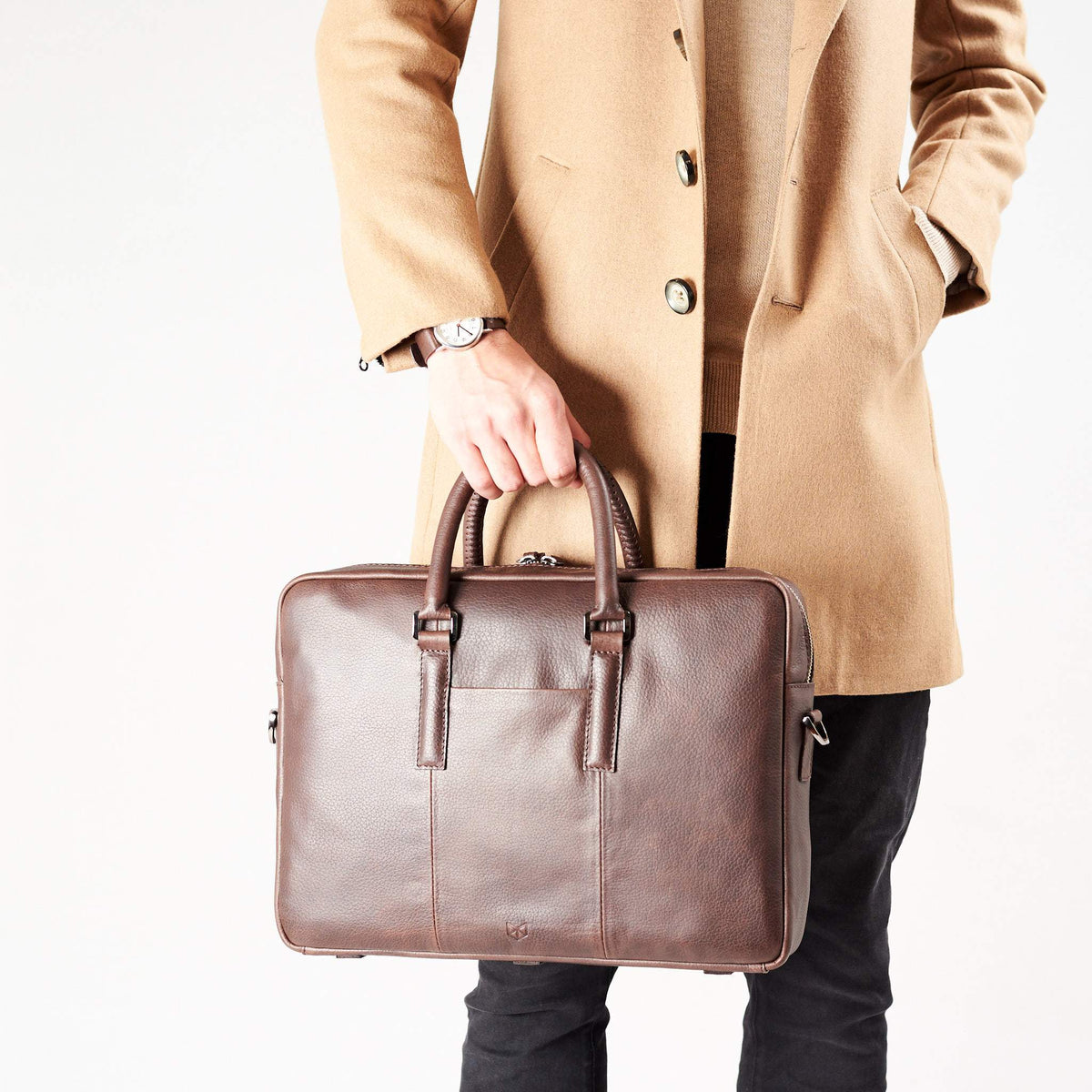Style view, model holding bussiness document portfolio bag .Dark Brown leather briefcase laptop bag for men. Gazeli laptop briefcase by Capra Leather.